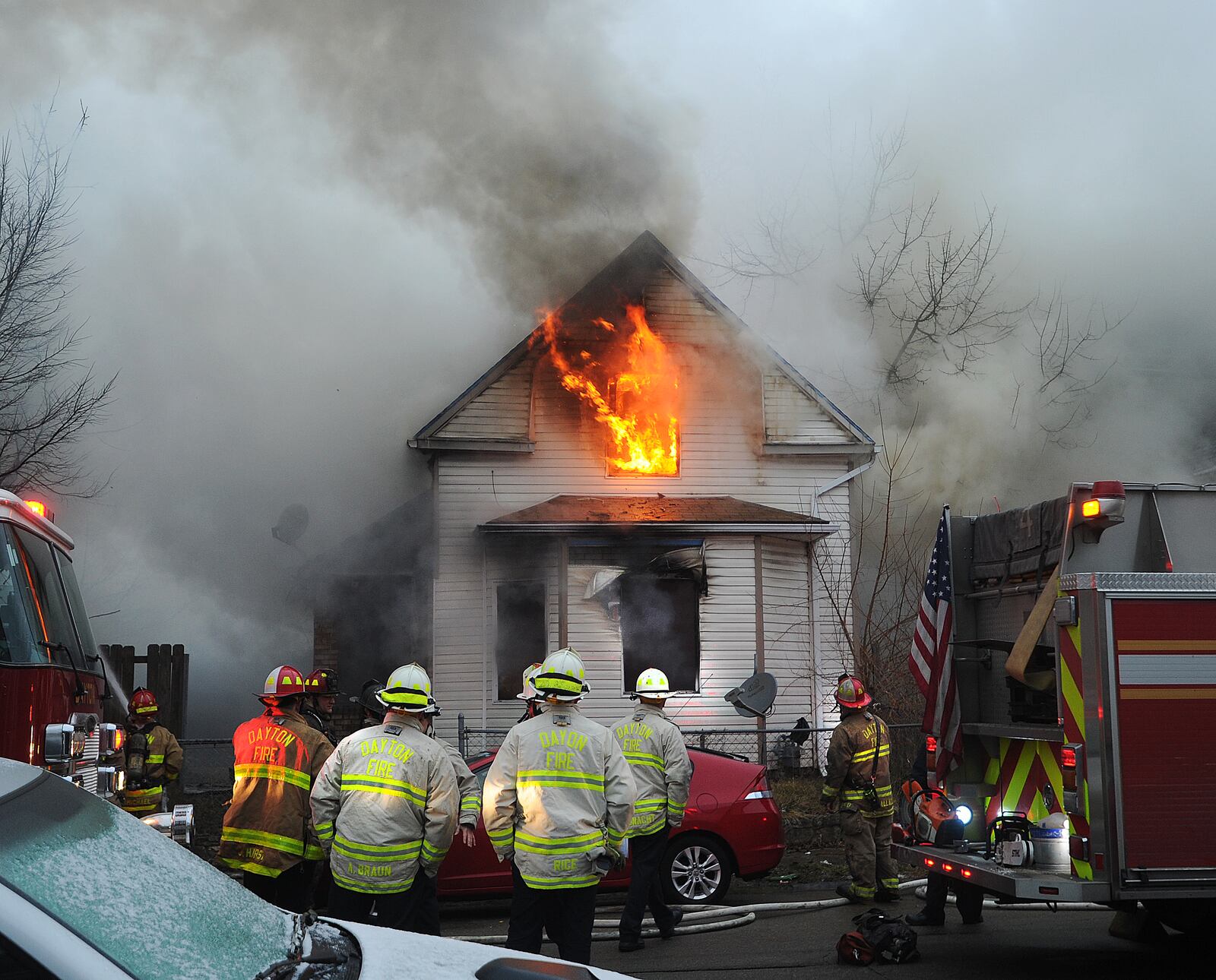 One person is custody in connection to a house fire in the 2600 block of East Second Street of Dayton on Monday morning. Two people jumped out of the window of the burning home. Dayton Fire Department Chief Jeff Lykins said that the fire is believed to be arson. MARSHALL GORBY/STAFF