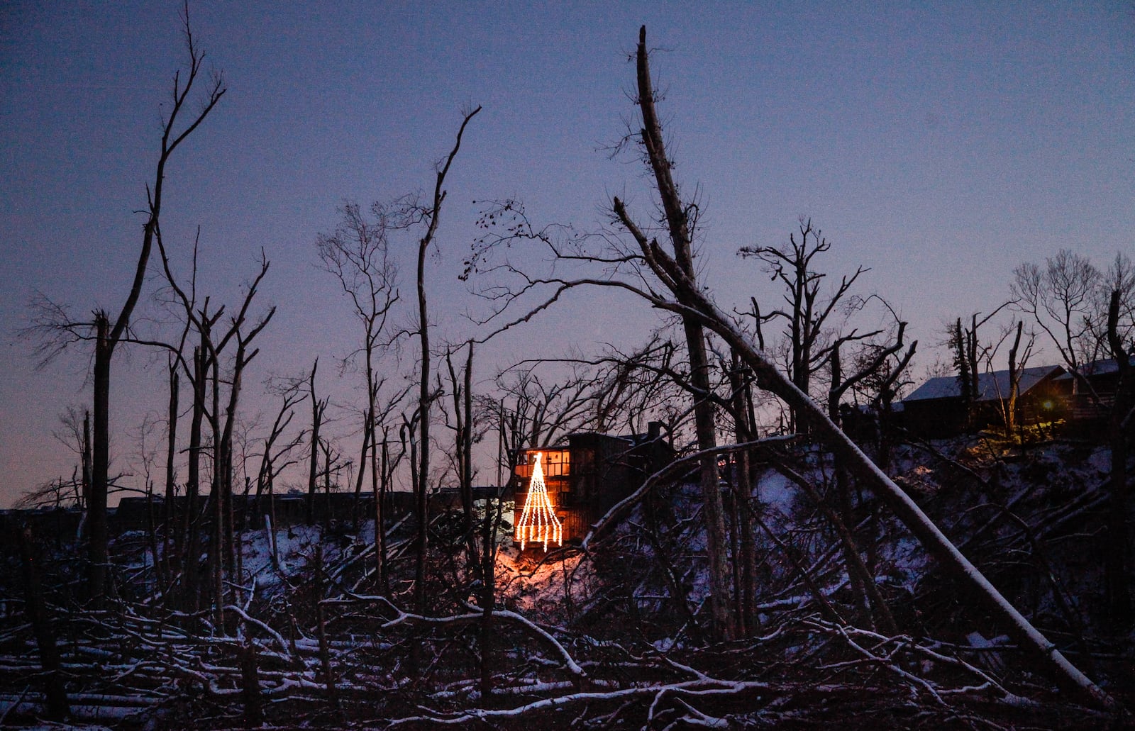 Allison Sandivarâs holiday display brightens the tornado-ravaged Stillwater River bank below her home in Harrison Twp. The Memorial Day tornado forced Sandivar from her home and her dog died within a week of the storm. Before the tornado it was difficult to see through the trees, she said. âAt night it sparkles because you can see the city a little bit. And in the morning, you can see the sun rise a lot more than you used to,â she said. âI try to take a moment and appreciate the things I didnât have before.â CHRIS STEWART / STAFF