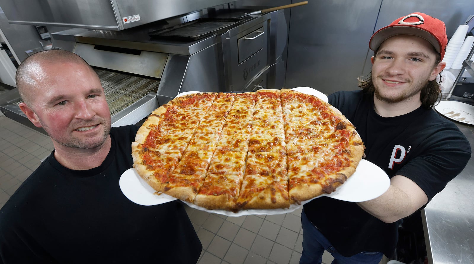 Mike Kinder, left and his nephew Parker Lenski owners of Pappas Pizza Palace located at 412 S. 1st Street in Miamisburg.  MARSHALL GORBY\STAFF