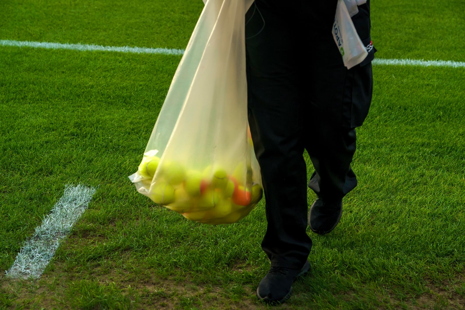 FILE - Pitch crews clean up after the home crowd threw tennis balls onto the pitch in a protest against VAR, shortly after kick-off in soccer match between Lillestrom and KFUM Oslo at Arasen Stadium in Oslo, June 27, 2024. (Cornelius Poppe/NTB via AP, file)