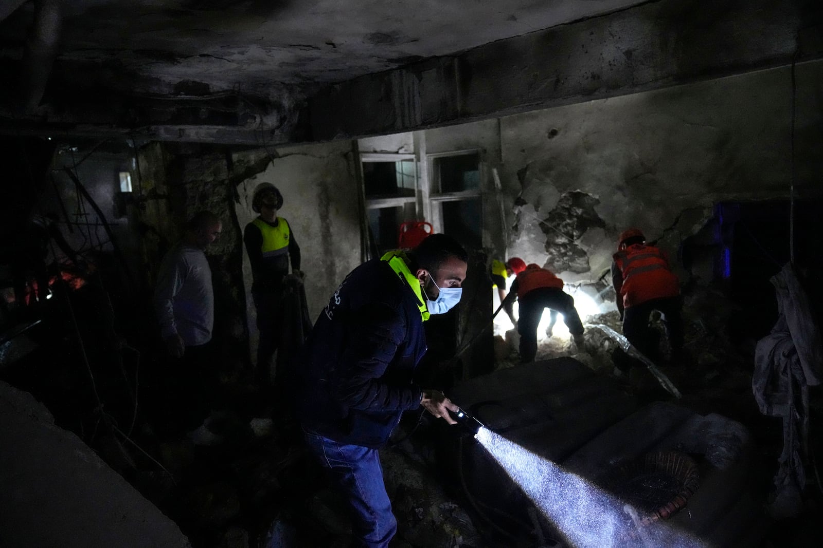 Rescue workers search for victims at the site of an Israeli airstrike in Beirut, Lebanon, Monday, Nov. 18, 2024. (AP Photo/Hussein Malla)