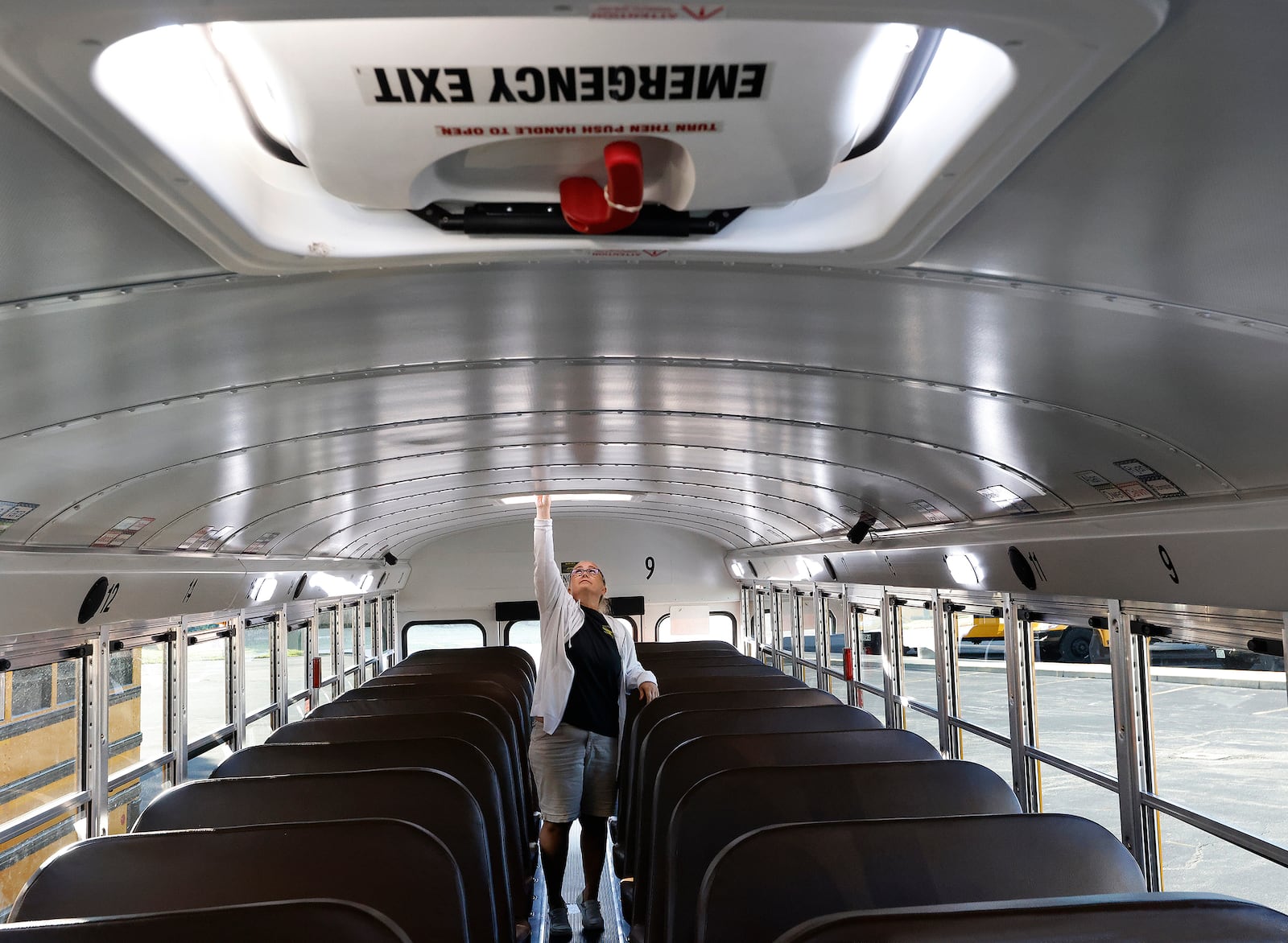 Centerville bus driver Janelle Kime checks the emergency exits and goes through her safety checks Tuesday, Aug. 20, 2024 on her bus before picking students. These checks are done every day. MARSHALL GORBY\STAFF