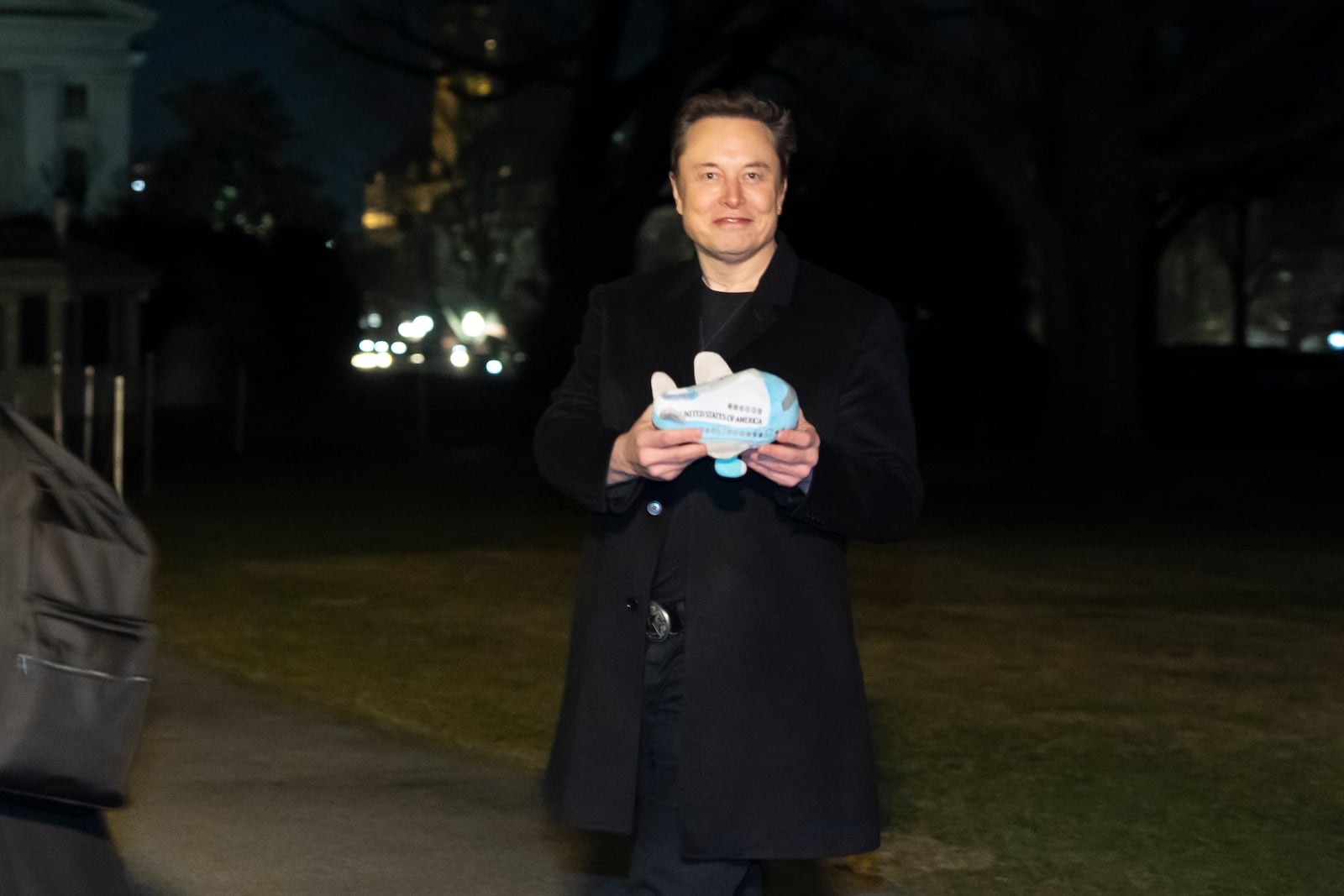 Elon Musk holds a stuffed Air Force One toy after arriving with President Donald Trump on Marine One on the South Lawn of the White House, Wednesday, Feb. 19, 2025, in Washington. (AP Photo/Alex Brandon)