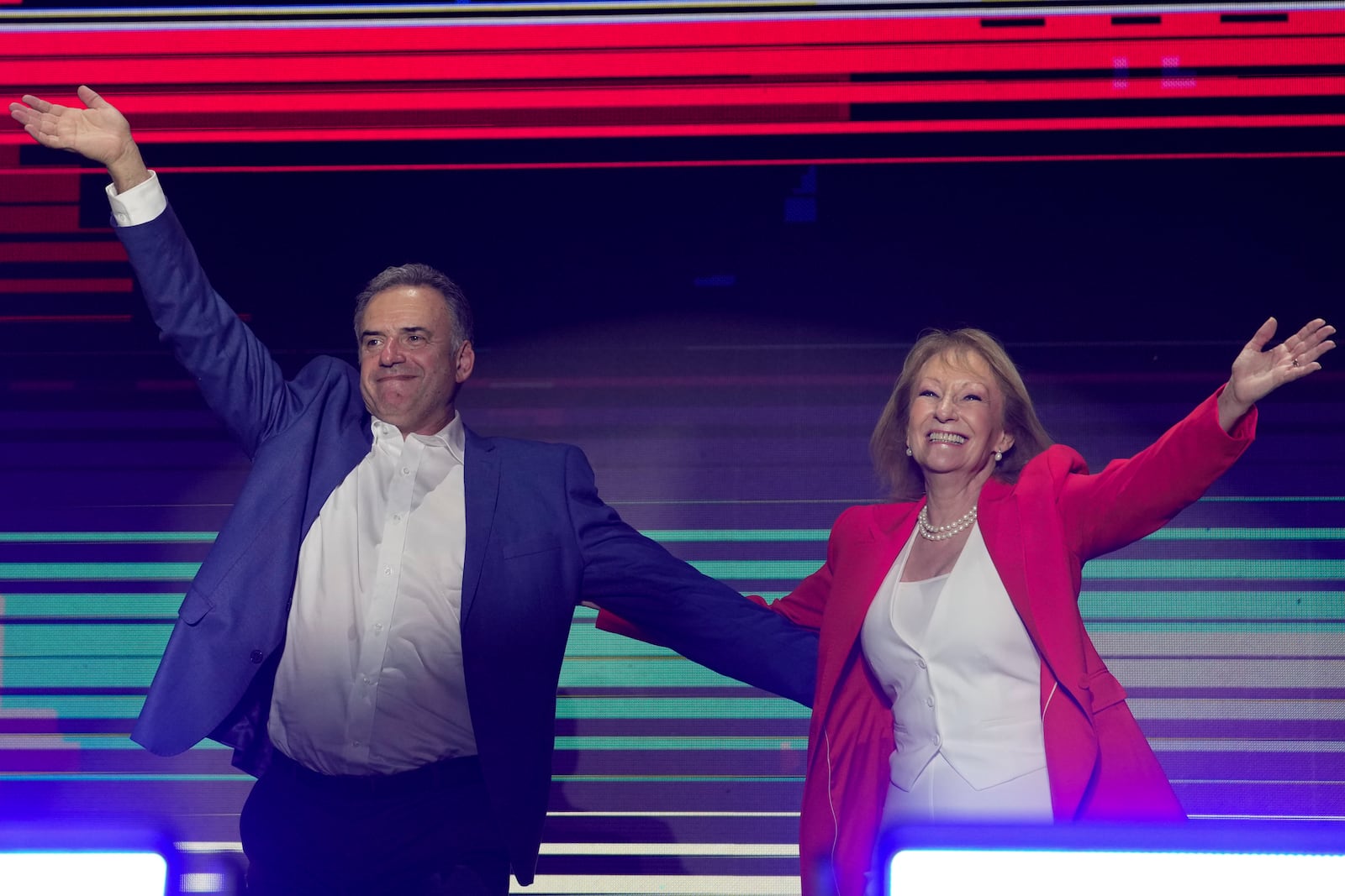 Yamandu Orsi, candidate for the Broad Front (Frente Amplio) and running mate Carolina Cosse, right, celebrate after polls closed in the presidential run-off election in Montevideo, Uruguay, Sunday, Nov. 24, 2024. (AP Photo/Natacha Pisarenko)