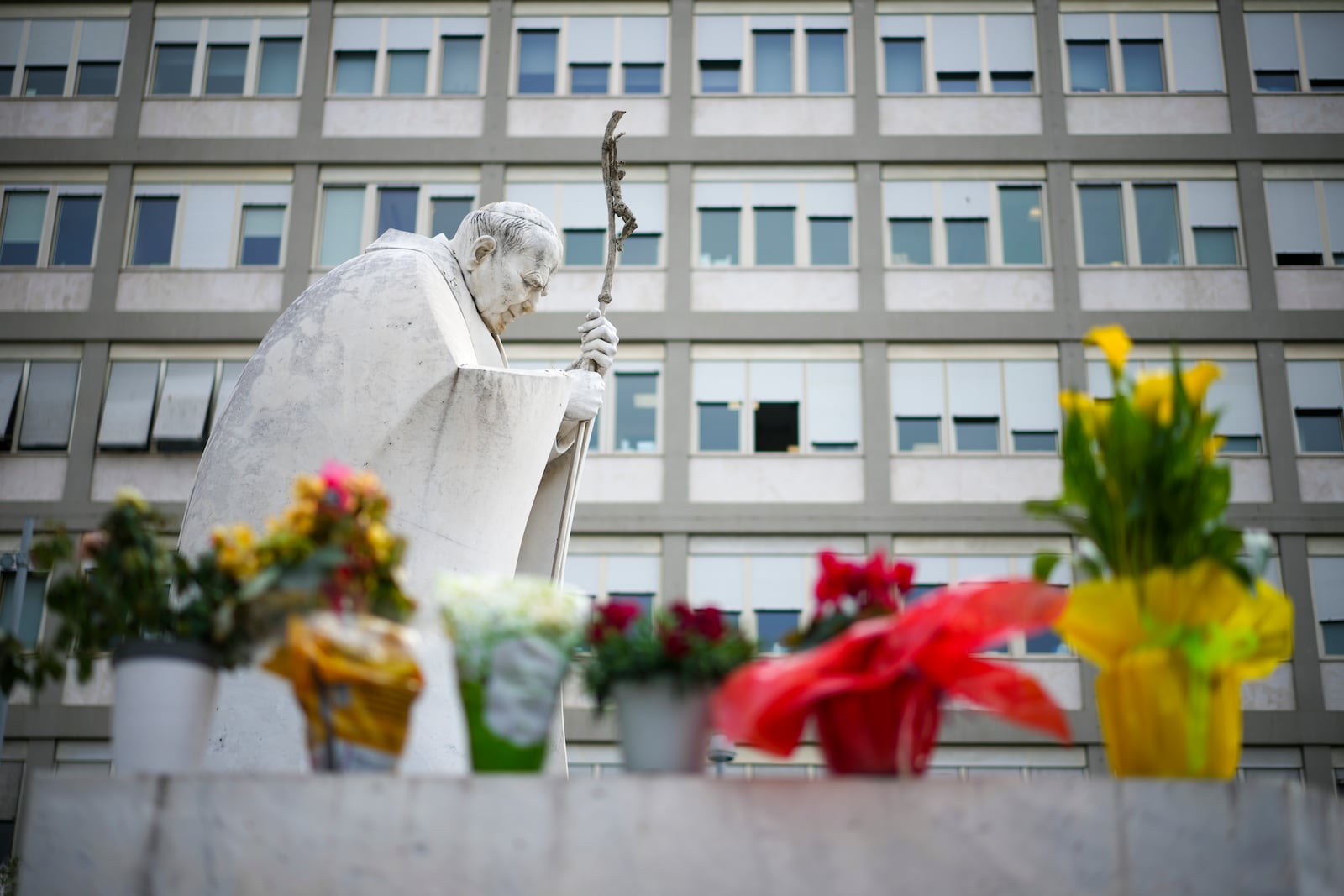 Flowers are left for Pope Francis in front of the Agostino Gemelli Polyclinic, in Rome, Saturday, March 8, 2025, where the Pontiff is hospitalized since Feb. 14. (AP Photo/Andrew Medichini)