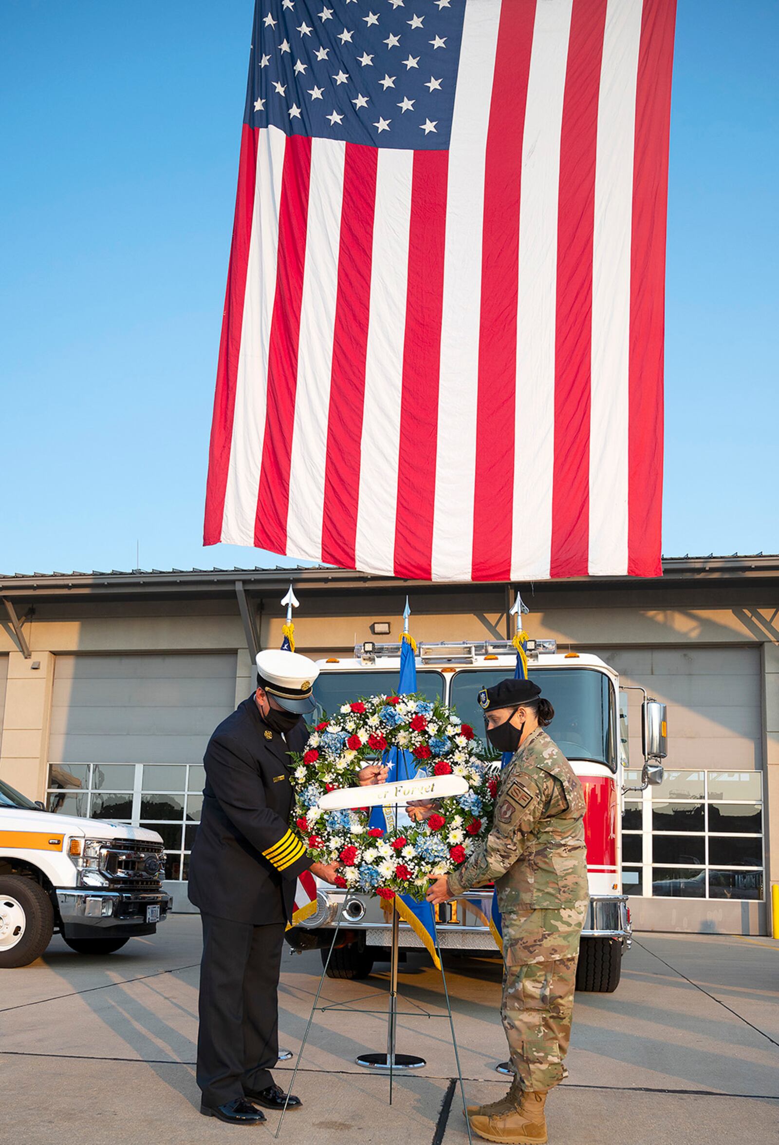 Jacob King, 788th Civil Engineer Squadron fire chief, and Lt. Col. Nicole Schatz, 88th Security Forces Squadron commander, place a wreath in front of Fire Station One during commemoration of the 20th anniversary of the 9/11 attacks Sept. 10 at Wright-Patterson Air Force Base. King and Schatz symbolized the firefighters and police officers killed in the attack. U.S. AIR FORCE PHOTO/R.J. ORIEZ