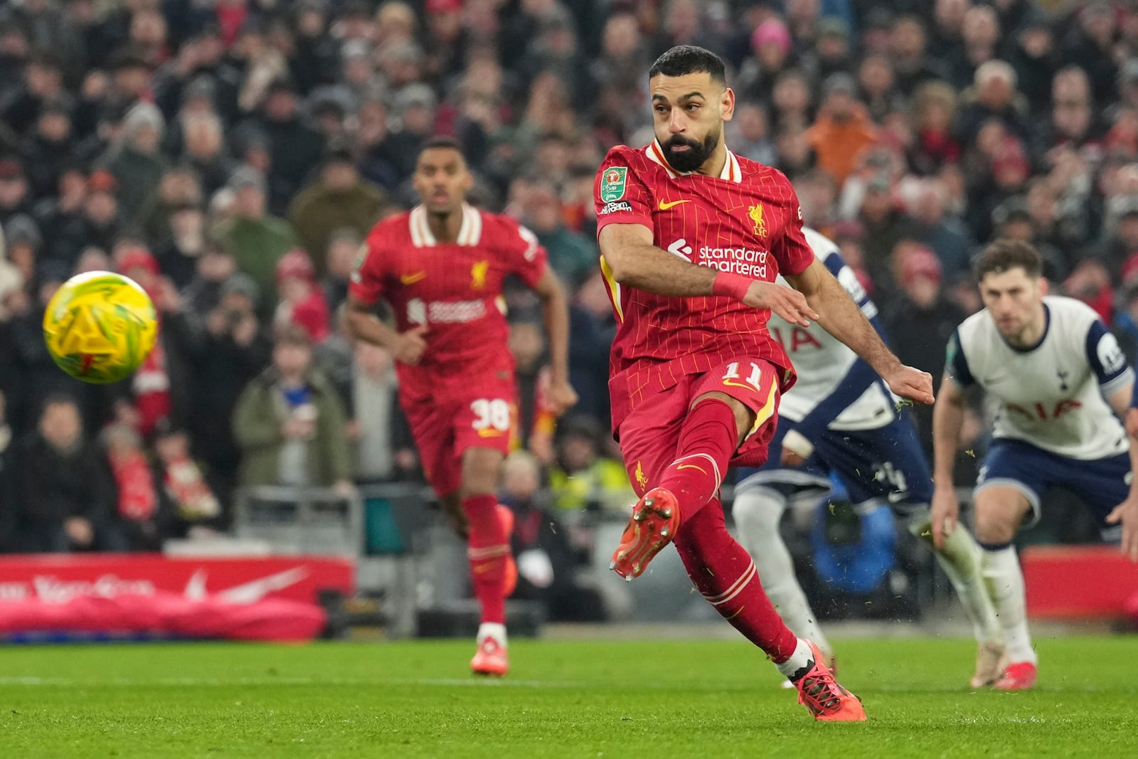 Liverpool's Mohamed Salah scores the second goal from the penalty spot during the English League Cup semifinal second leg soccer match between Liverpool and Tottenham Hotspur at Anfield Stadium in Liverpool, England, Thursday, Feb. 6, 2025. (AP Photo/Jon Super)