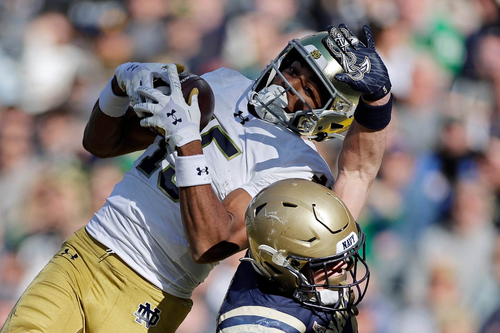 Notre Dame cornerback Leonard Moore (15) intercepts a pass in the end zone over Navy running back Eli Heidenreich (22) during the second half of an NCAA college football game Saturday, Oct. 26, 2024, in East Rutherford, N.J. (AP Photo/Adam Hunger)