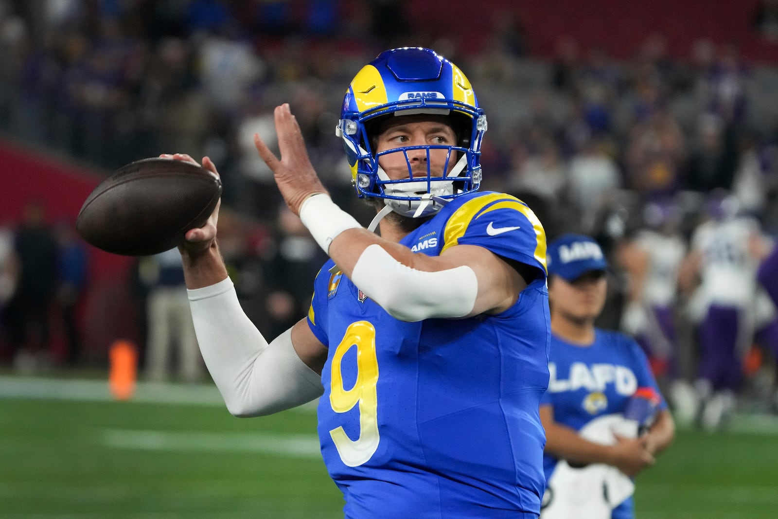 Los Angeles Rams quarterback Matthew Stafford (9) throws before an NFL wild card playoff football game against the Minnesota Vikings, Monday, Jan. 13, 2025, in Glendale, Ariz. (AP Photo/Rick Scuteri)