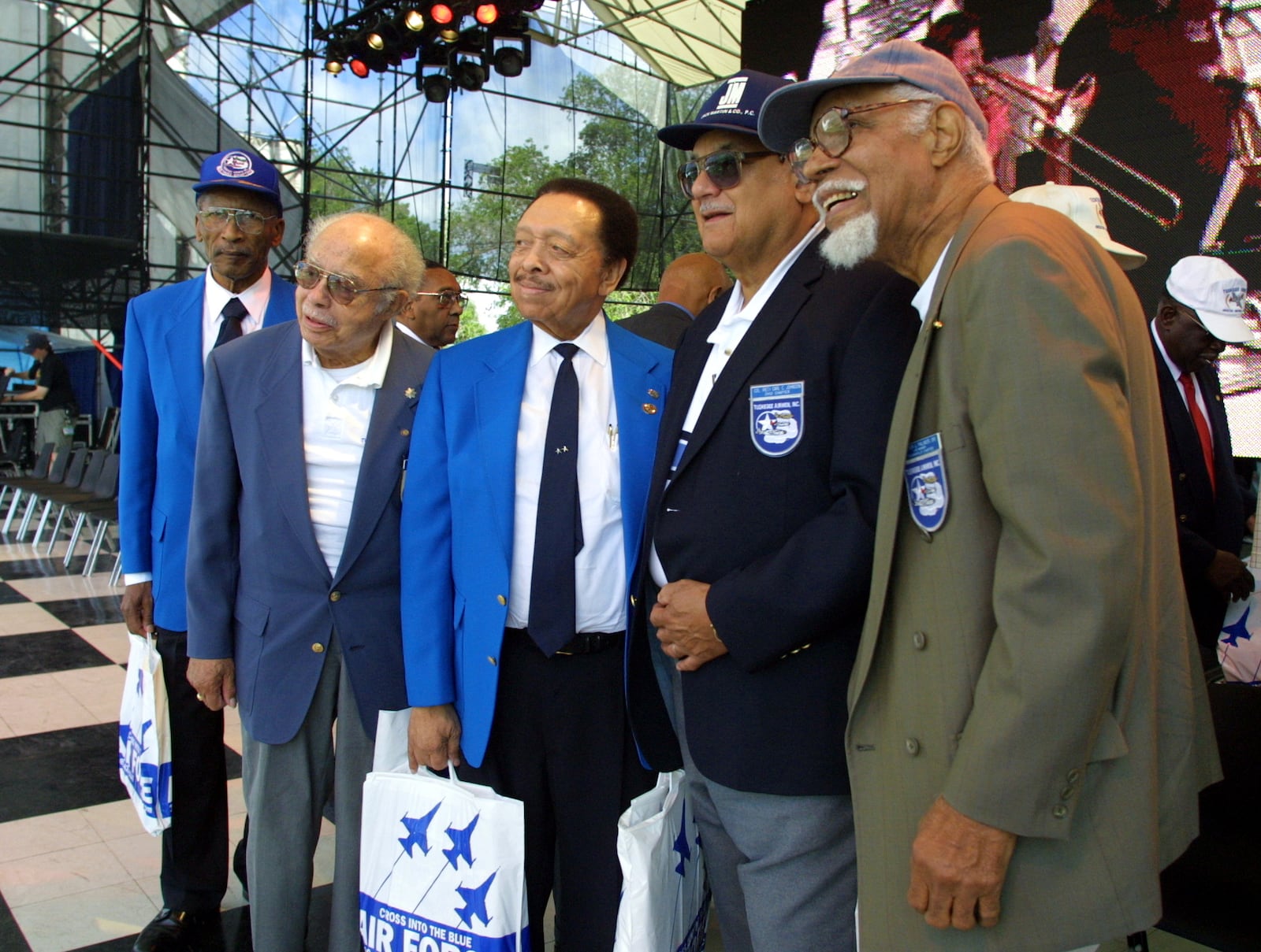 A group of Tuskegee Airmen pose for a picture following a ceremony honoring them on the main stage at Celebration Central. They are: (left to right) James Hayes, Col. Bill Thompson, Maj. Gen. Lucius Theus, Col. Carl Johnson and Walter Palmer.