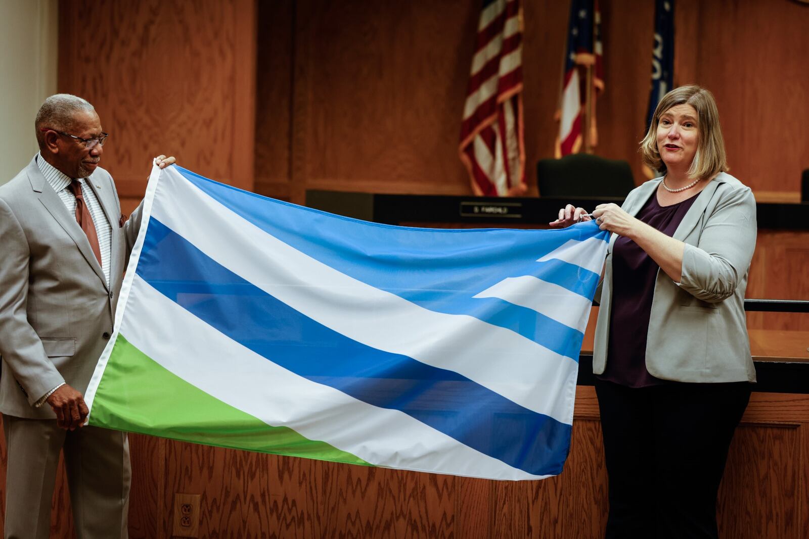 Dayton mayor elect, Jeffrey Mims Jr. left, and mayor, Nan Whaley display the new Dayton flag City Hall Wednesday Dec. 15, 2021. JIM NOELKER/STAFF