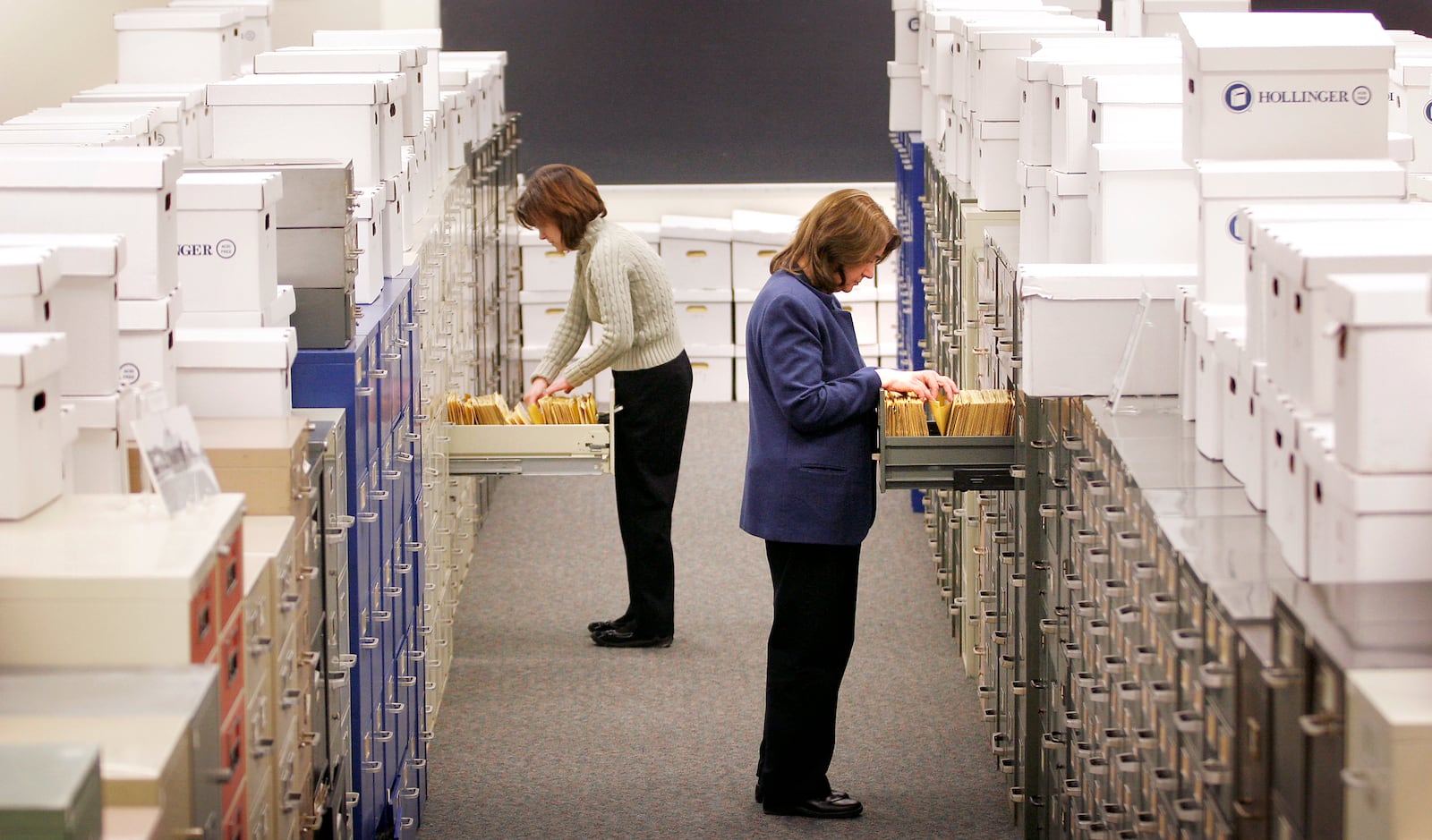 Wright State University archivist Toni Vanden Bos, left, and Dawne Dewey, head of Wright State's Special Collections and Archives, sift through the Dayton Daily News physical archive in 2009  housed at the Wright State University.