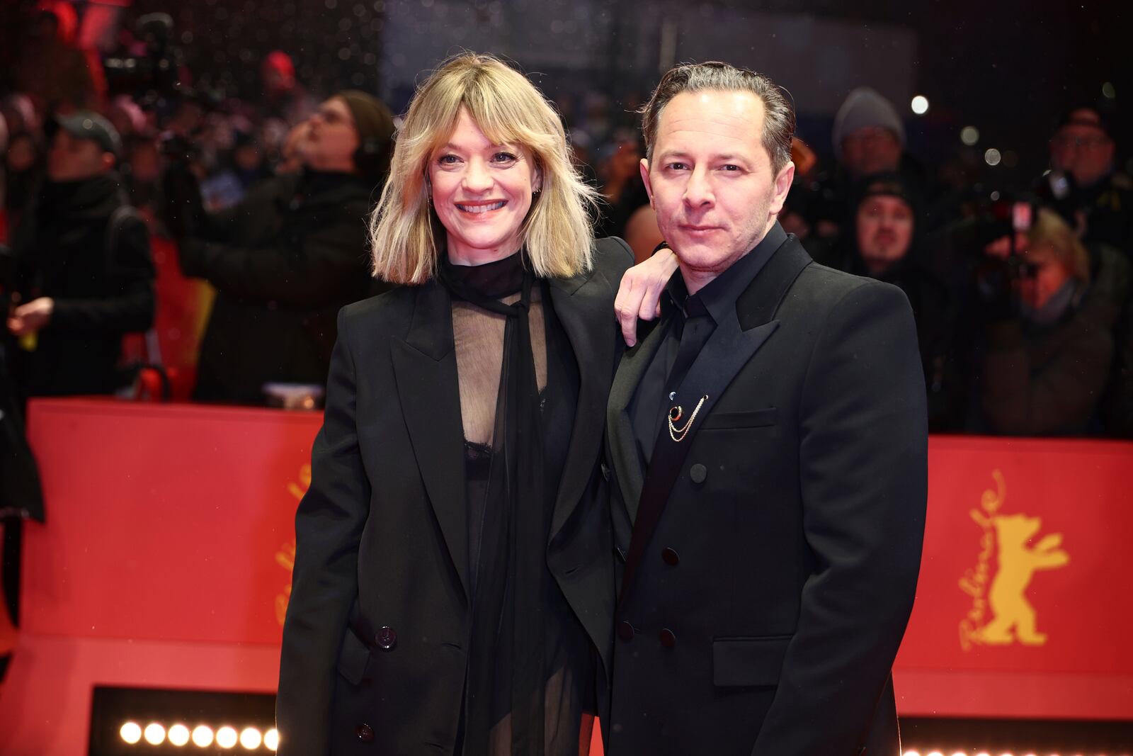 Actress Heike Makatsch and her boyfriend, actor Trystan Puetter, pose for photographers upon arrival at the opening of the International Film Festival, Berlinale, in Berlin, Thursday, Feb. 13, 2025. (Christoph Soeder//dpa via AP)