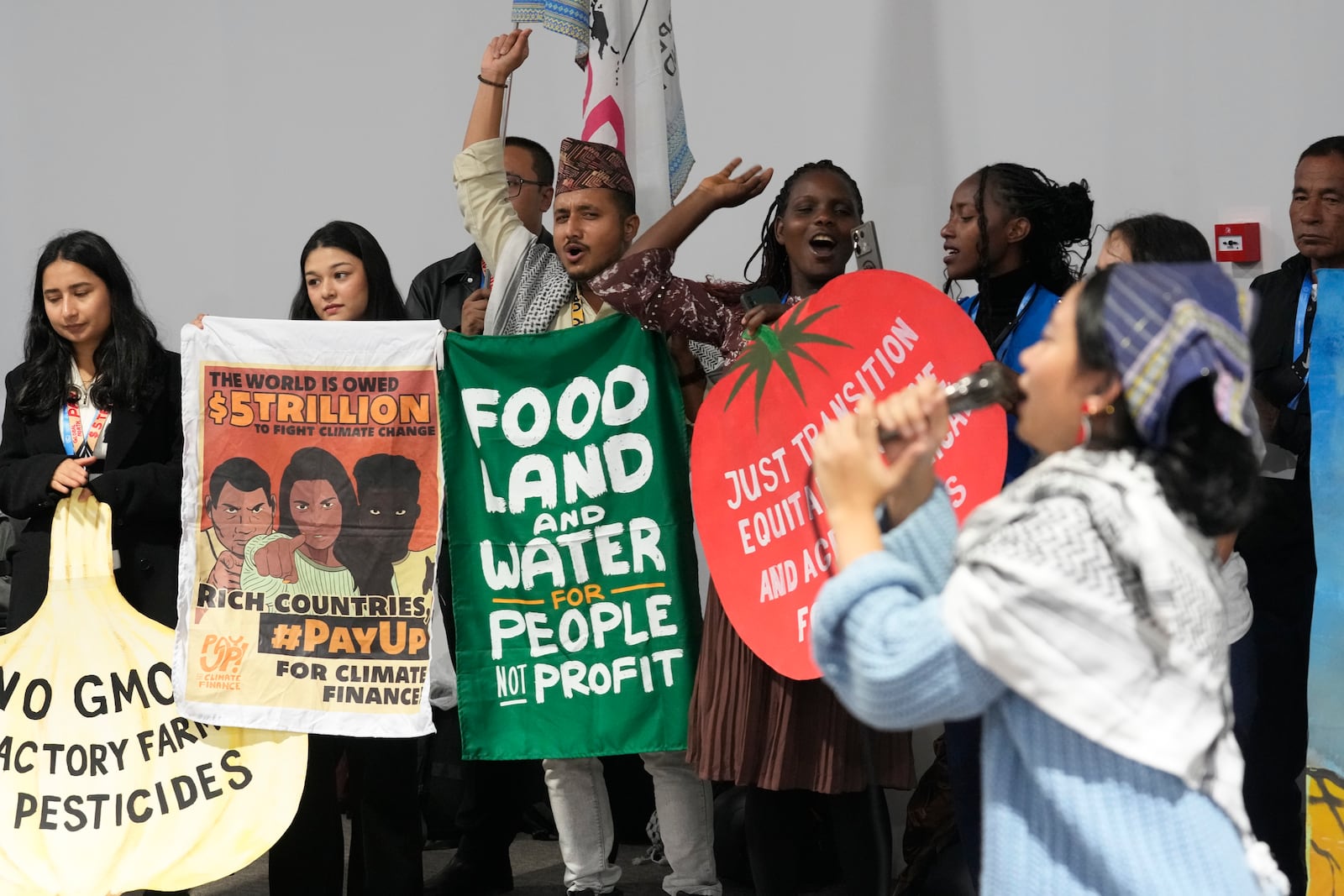 Activists participate in a demonstration for transforming food systems at the COP29 U.N. Climate Summit, Tuesday, Nov. 19, 2024, in Baku, Azerbaijan. (AP Photo/Rafiq Maqbool)