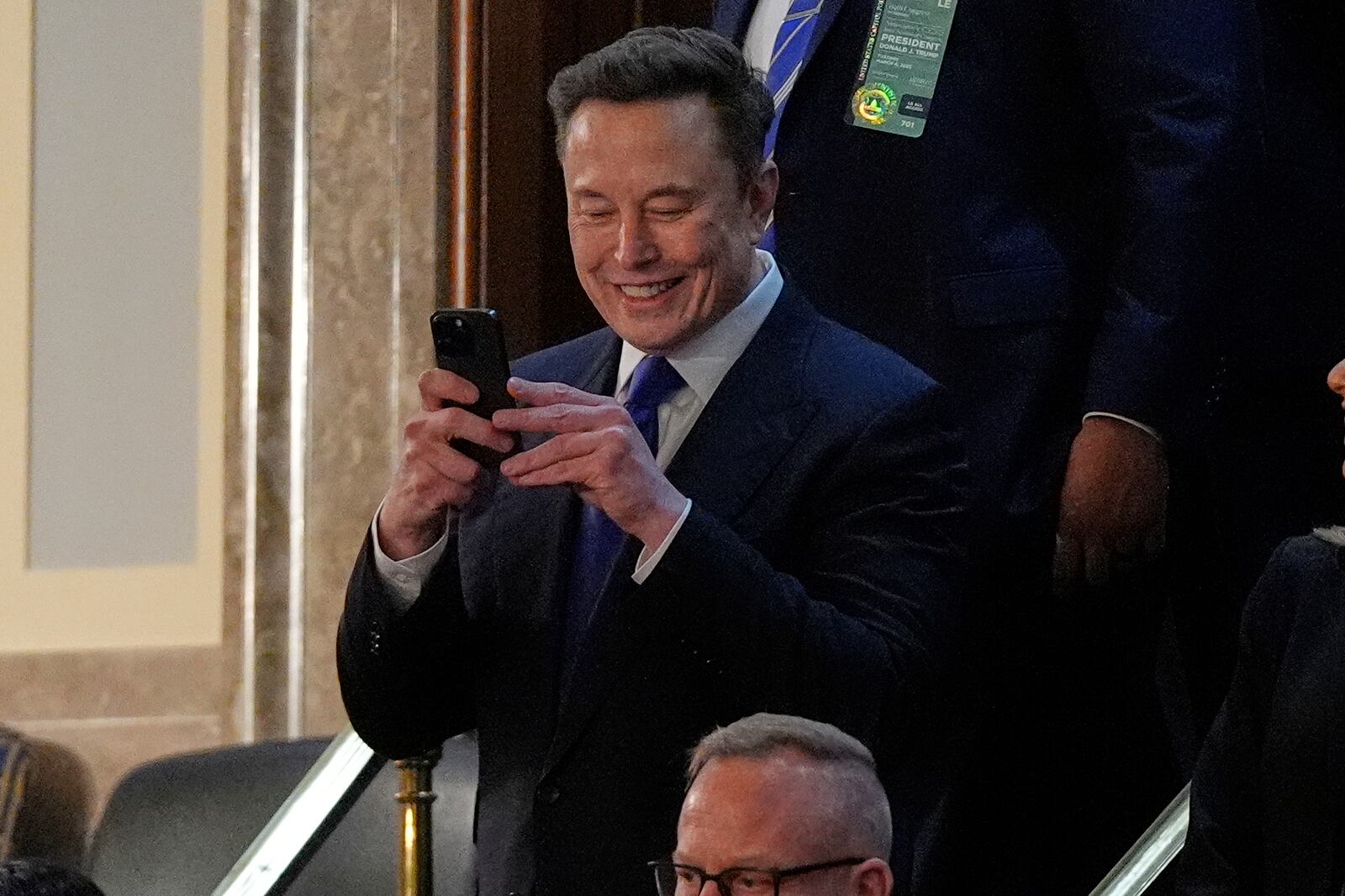 Elon Musk takes a photo as he arrives before President Donald Trump addresses a joint session of Congress in the House chamber at the U.S. Capitol in Washington, Tuesday, March 4, 2025. (AP Photo/Julia Demaree Nikhinson)