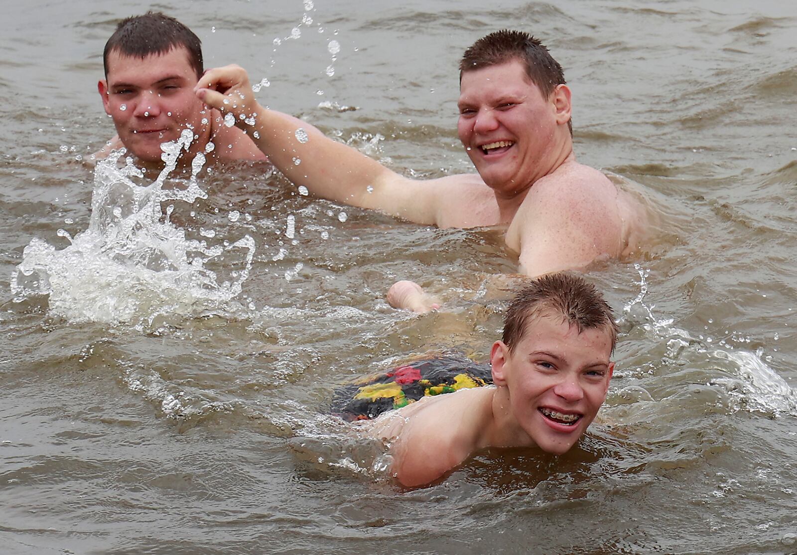 Arlyn, Logan and Travis Martin didn't let the cool weather or anything else stop them from enjoying their time at the beach at Buck Creek State Park Friday, June 16, 2023. The brothers were on vacation with their family from Missouri. BILL LACKEY/STAFF