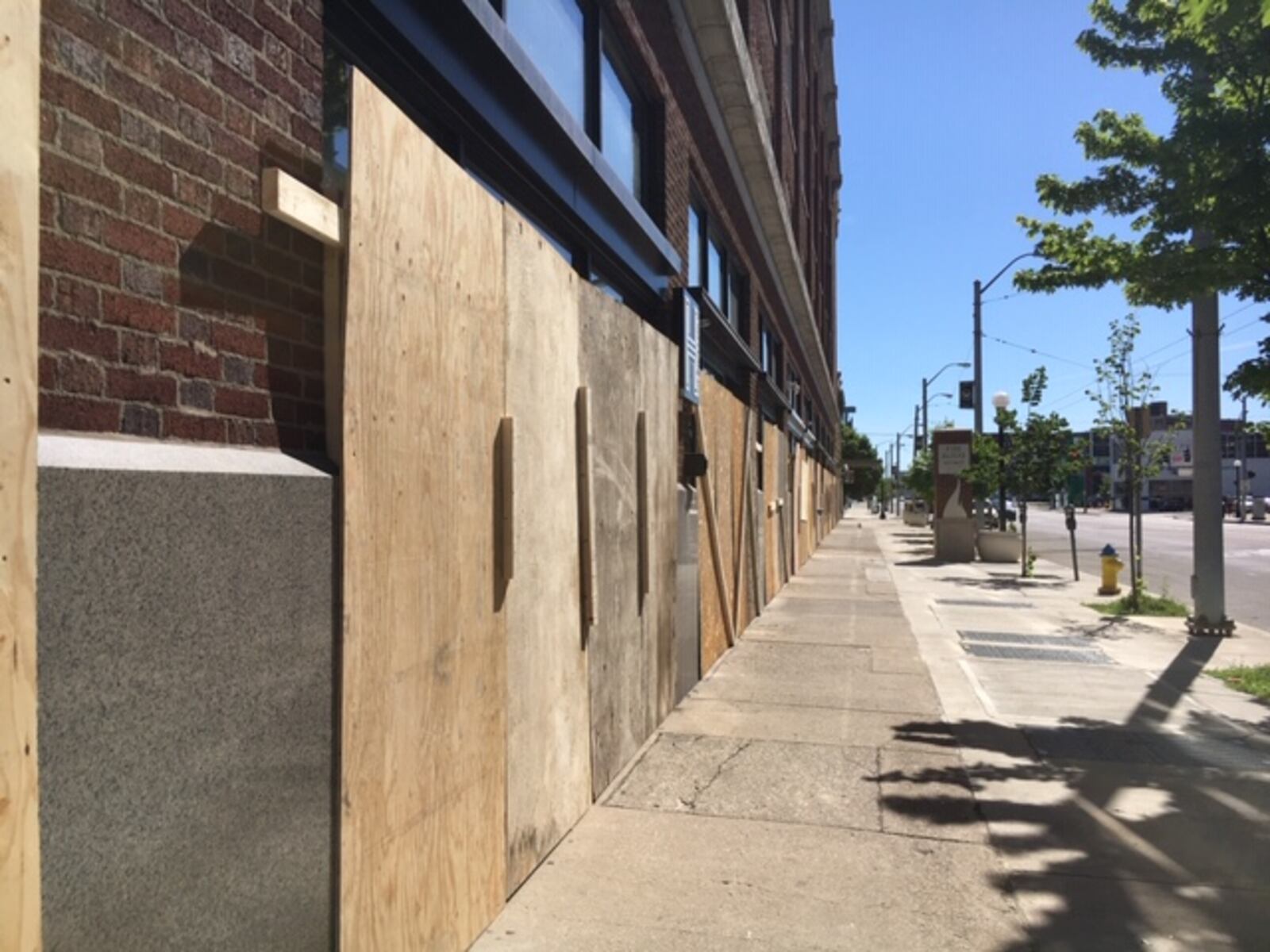 Windows and doors boarded up on East Third Street Monday morning. 