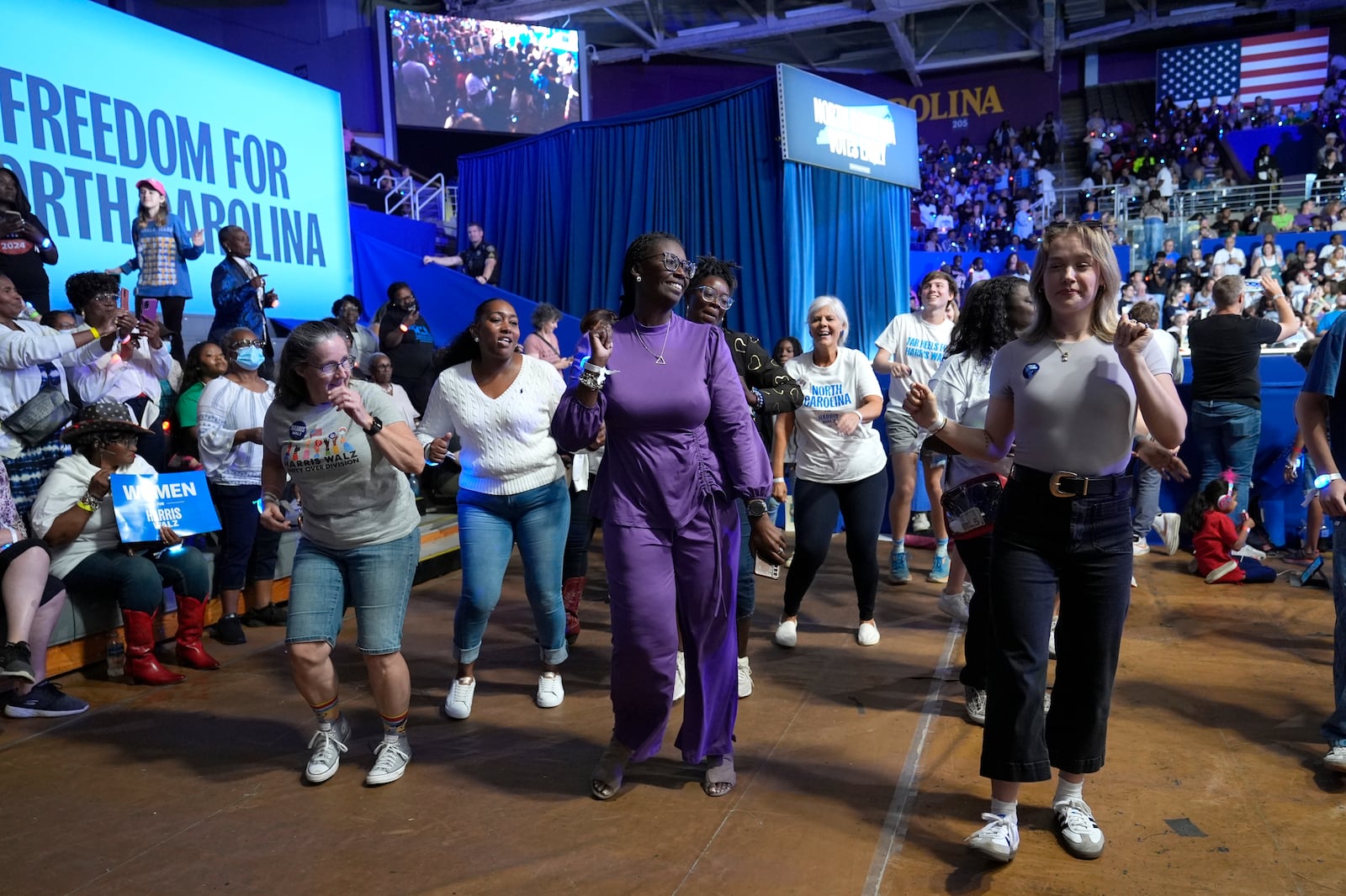 Attendees dance before Democratic presidential nominee Vice President Kamala Harris arrives to speak at a campaign rally at East Carolina University in Greenville, N.C., Sunday, Oct. 12, 2024. (AP Photo/Susan Walsh)