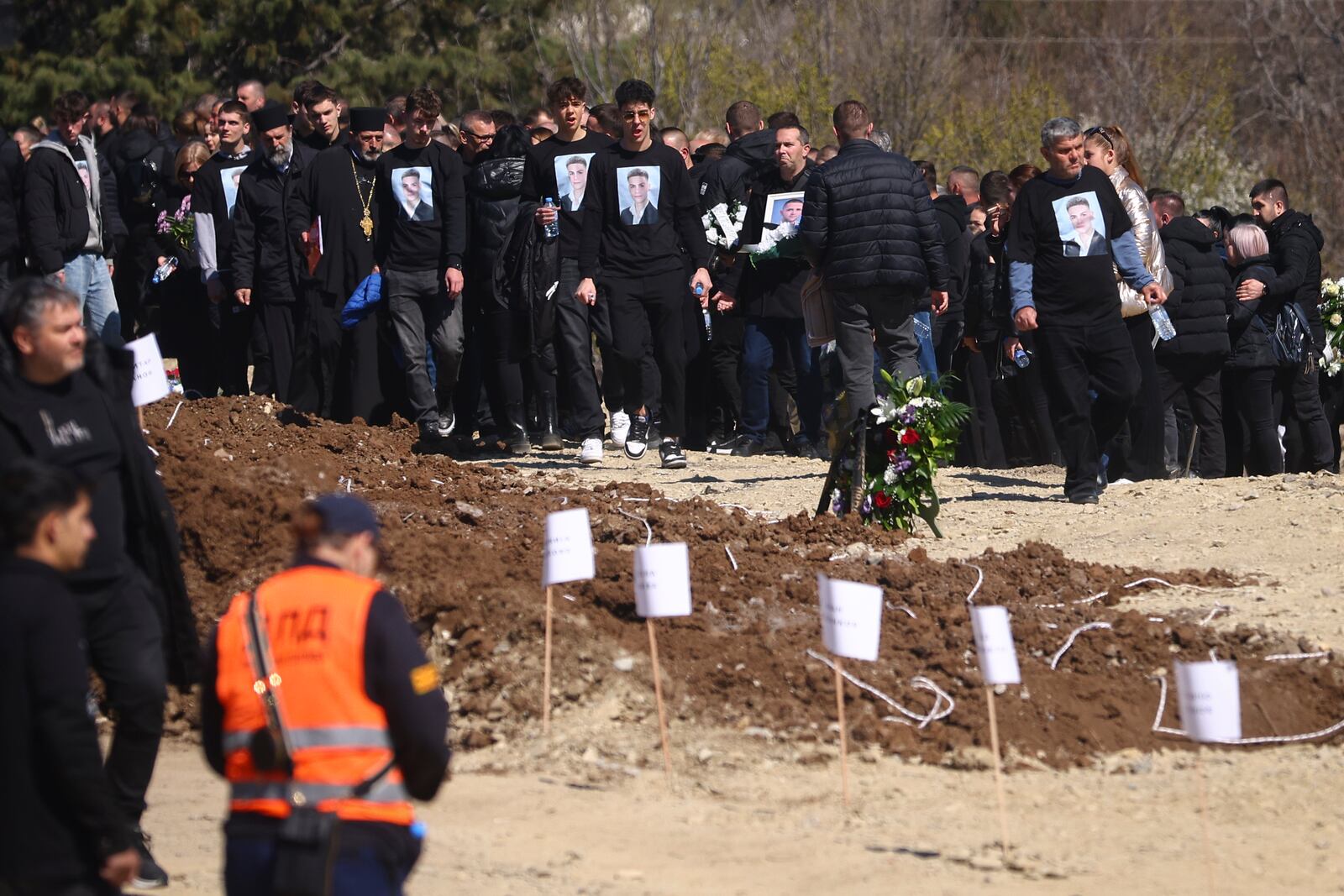 People gather at a cemetery for the funeral ceremony of the victims of a massive nightclub fire in the town of Kocani, North Macedonia, Thursday, March 20, 2025. (AP Photo/Armin Durgut)