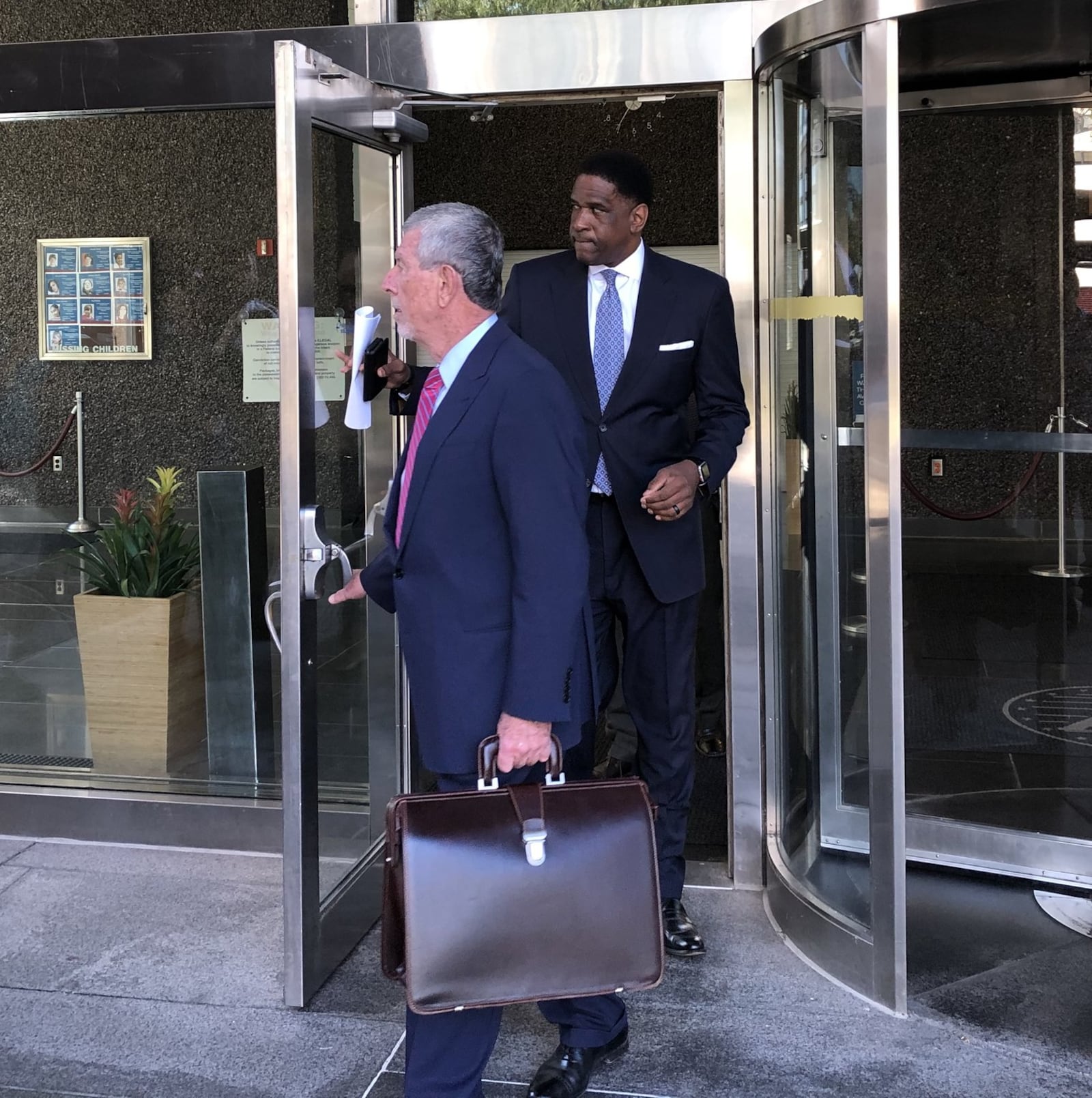 Former Dayton City Commissioner Joey D. Williams (right) and his attorney, Patrick John Hanley (left), leave the federal court building in Dayton after Williams on Sept. 27, 2019 pleaded guilty to one count of corruptly soliciting a bribe. LYNN HULSEY/Staff