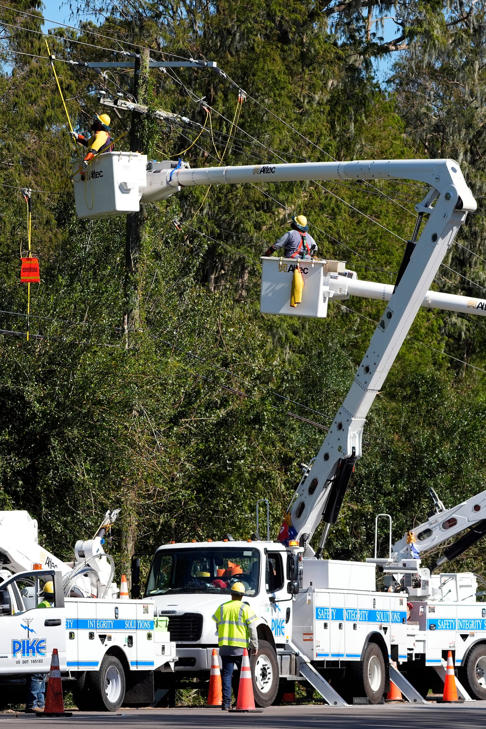 Pike Corporation linemen, of North Carolina, repair power lines damaged by Hurricane Milton Monday, Oct. 14, 2024, in Lithia, Fla. (AP Photo/Chris O'Meara)