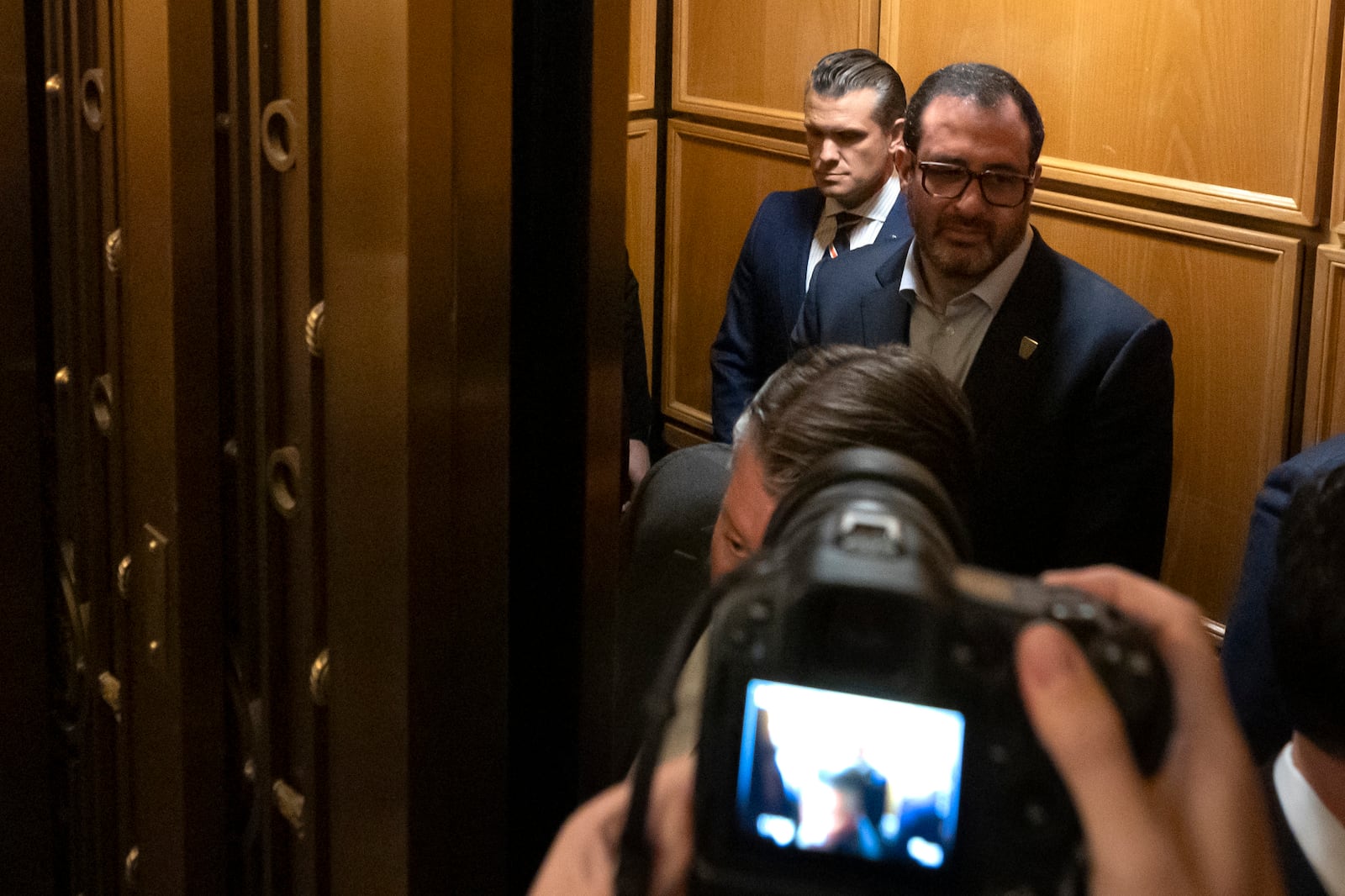 Pete Hegseth, President-elect Donald Trump's pick for Secretary of Defense, in back, stands in an elevator after meeting with senators on Capitol Hill, Thursday, Nov. 21, 2024, in Washington. (AP Photo/Mark Schiefelbein)