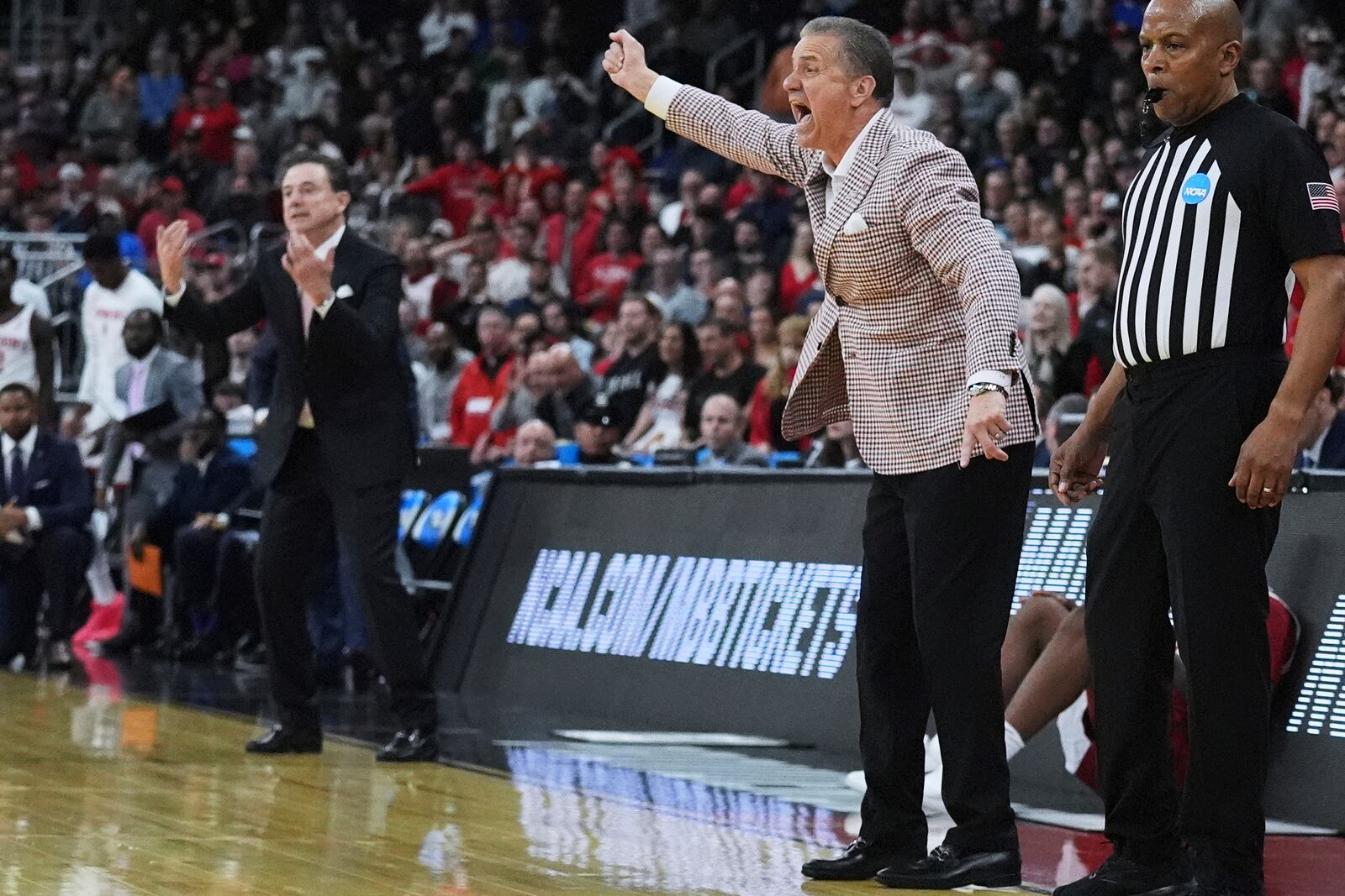 Arkansas head coach John Calipari, right, and St. John's head coach Rick Pitino, left, call to their players during the second half in the second round of the NCAA college basketball tournament, Saturday, March 22, 2025, in Providence, R.I. (AP Photo/Charles Krupa)