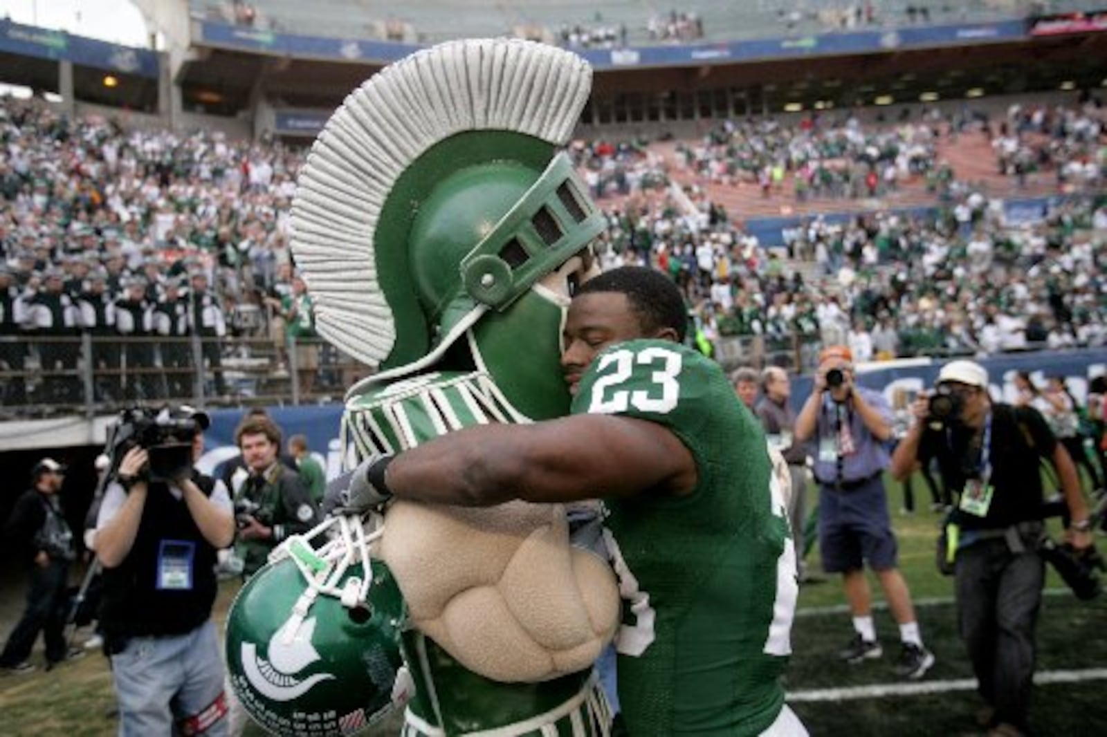 Michigan State running back Javon Ringer (23) hugs team mascot Sparty after their 24-12 loss to Georgia in the Capital One Bowl NCAA college football game on Thursday, Jan. 1, 2009, in Orlando, Fla. (AP Photo/Detroit Free Press, Rashaun Rucker) 