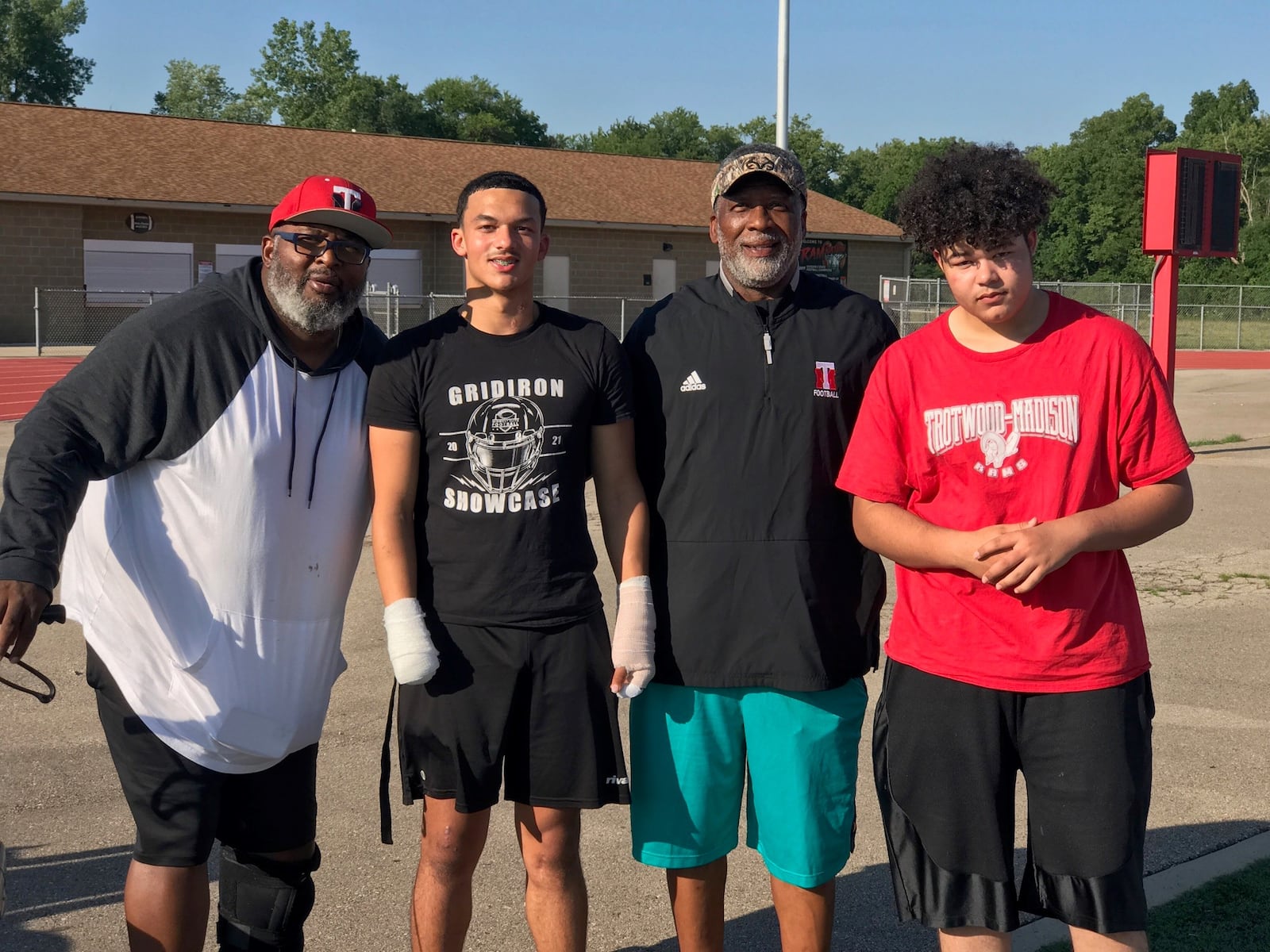 (left to right) Trotwood Madison assistant coach Kerry Ivy, Issiah Evans, head coach Jeff Graham and Garfield Evans. (Photo by Tom Archdeacon)