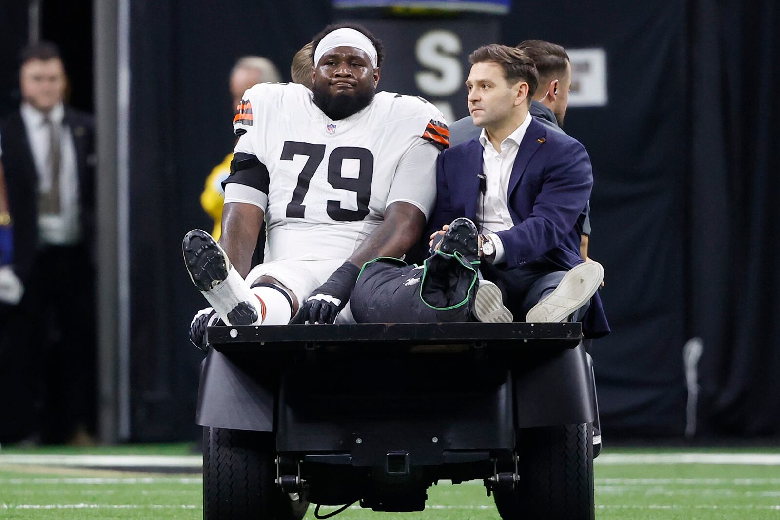 Cleveland Browns offensive tackle Dawand Jones (79) is carted off the field after an injury in the first half of an NFL football game against the New Orleans Saints in New Orleans, Sunday, Nov. 17, 2024. (AP Photo/Butch Dill)