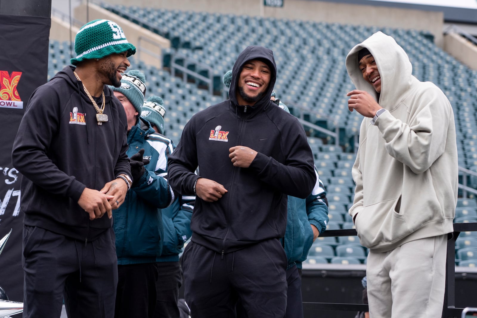 Philadelphia Eagles running back Saquon Barkley, center, interacts with cornerback Darius Slay Jr., left, and wide receiver DeVonta Smith (6), right, during the Eagles Send Off Party for Super Bowl LIX, Sunday, Feb. 2, 2025, in Philadelphia. (AP Photo/Chris Szagola)