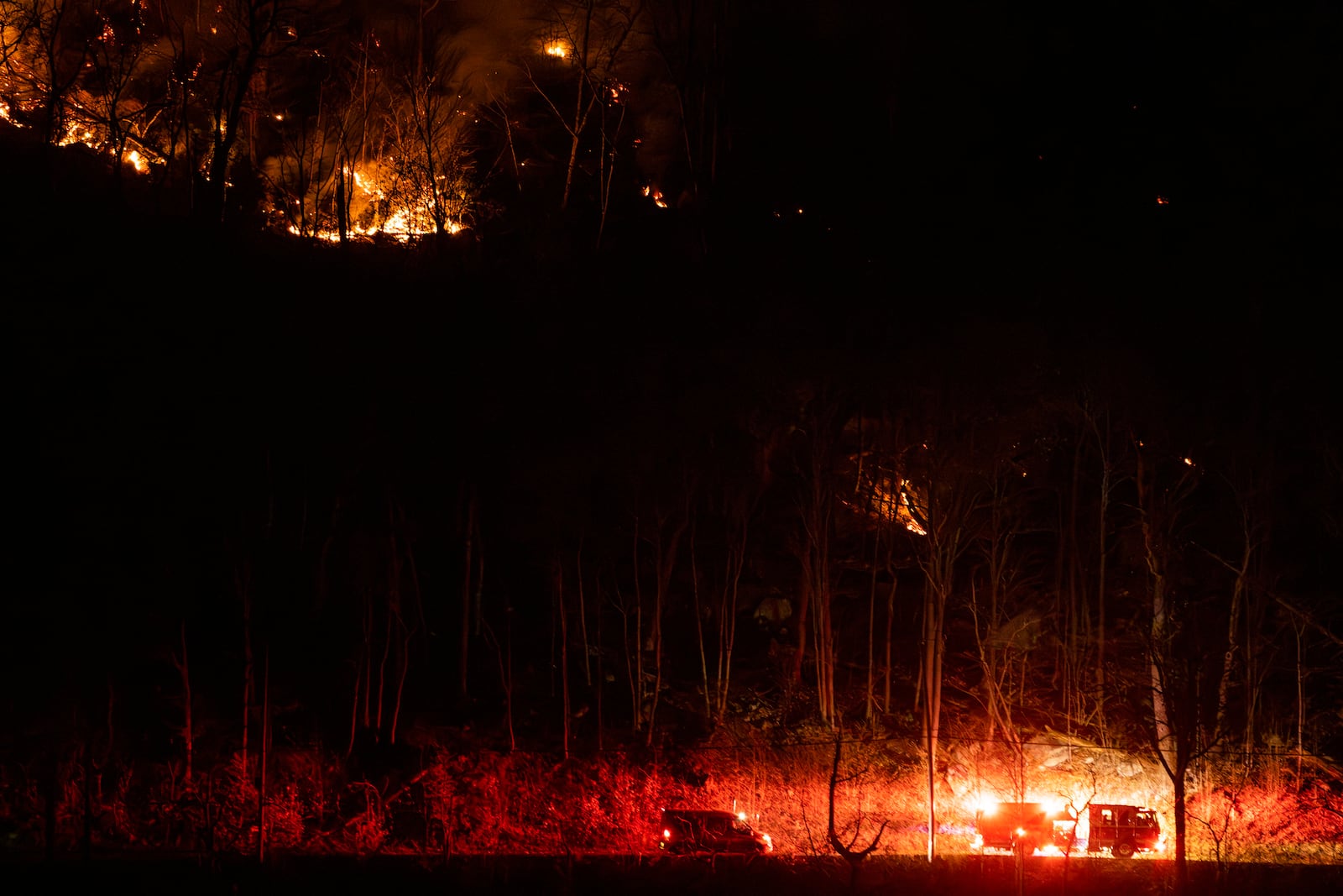 Firefighters attend the wildfires as they burn along the New York and New Jersey border in Greenwood Lake, New York, Wednesday, Nov. 13, 2024. (AP Photo/Eduardo Munoz Alvarez)