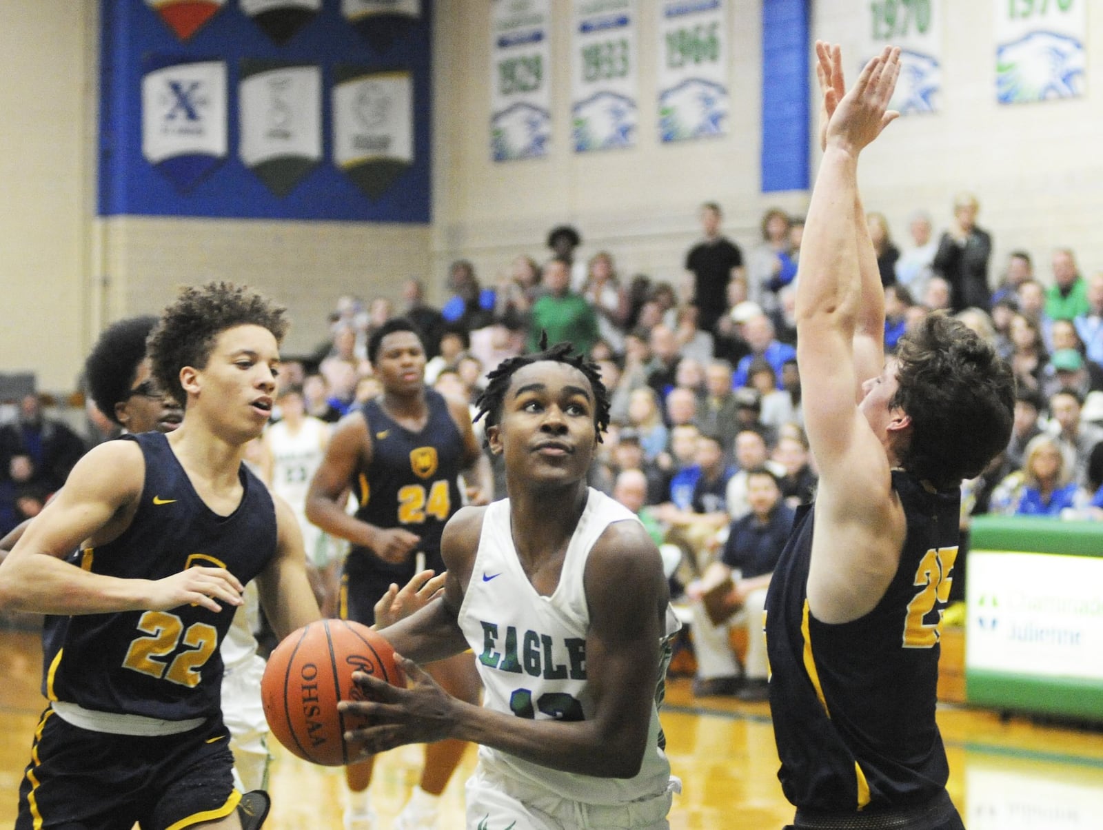 CJ’s Brandon Gibson (with ball) splits defenders Max Land (left) and Michael Currin. CJ lost to visiting Cin. Moeller 62-55 in a boys high school basketball game on Sat., Feb. 2, 2019. MARC PENDLETON / STAFF