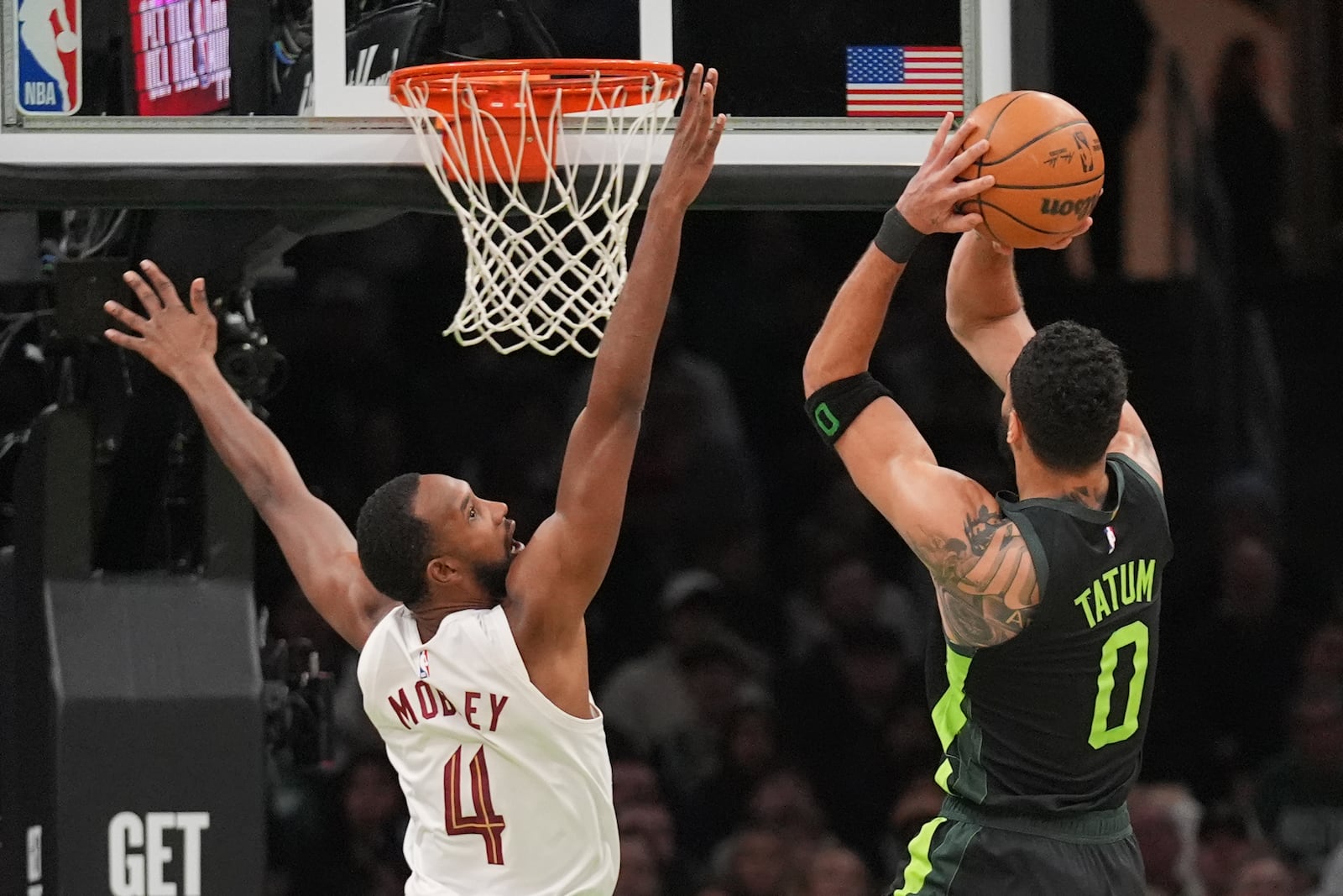 Cleveland Cavaliers forward Evan Mobley (4) tries to block a shot by Boston Celtics forward Jayson Tatum (0) during the first half of an NBA basketball game, Friday, Feb. 28, 2025, in Boston. (AP Photo/Charles Krupa)