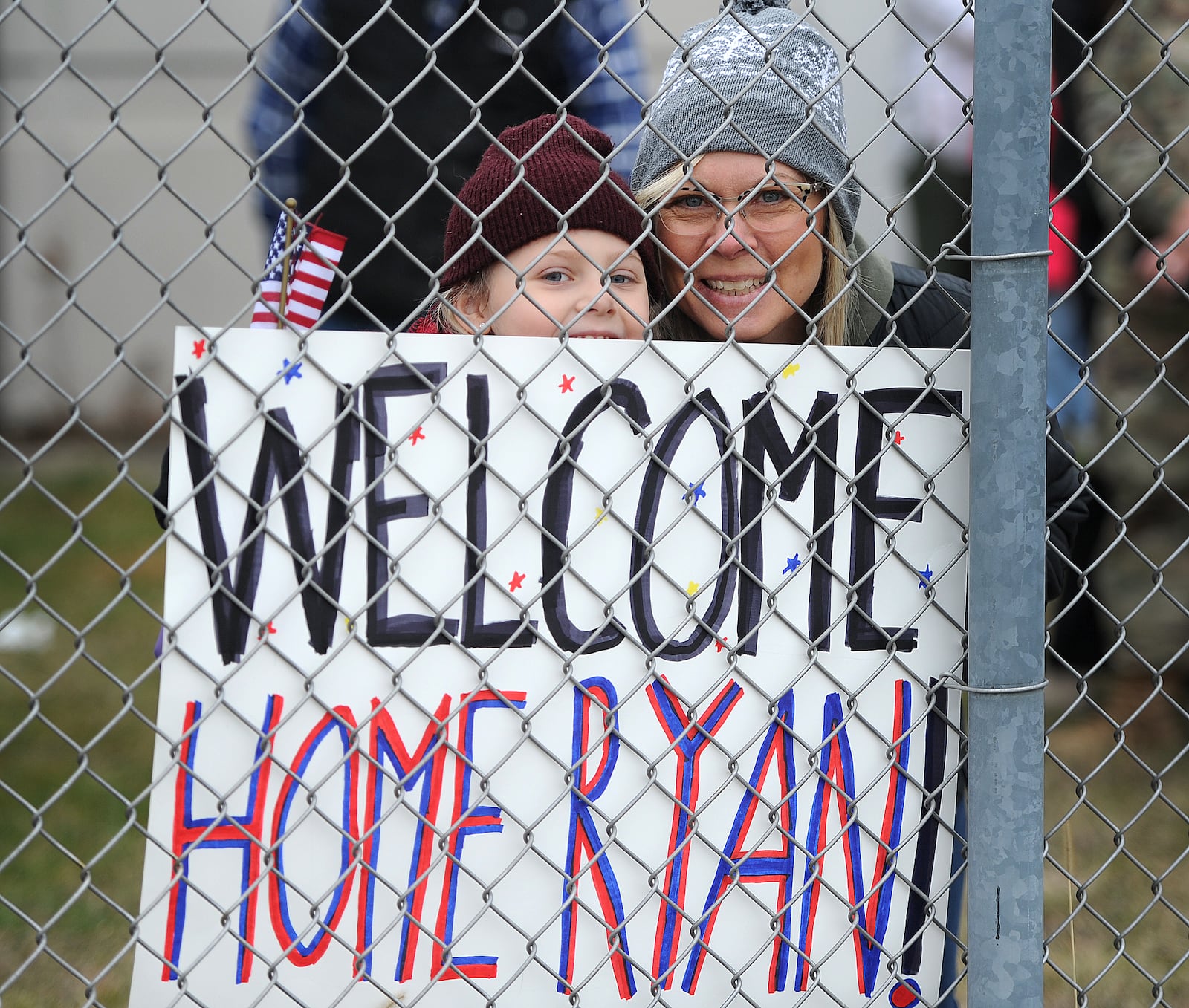 Families wait for their love ones to arrive home Thursday, Jan. 2024 in a C-17 Globemaster cargo plane, the Airmen returned to Wright-Patterson Air Force Base from more than two months deployed at an undisclosed location. MARSHALL GORBY\STAFF