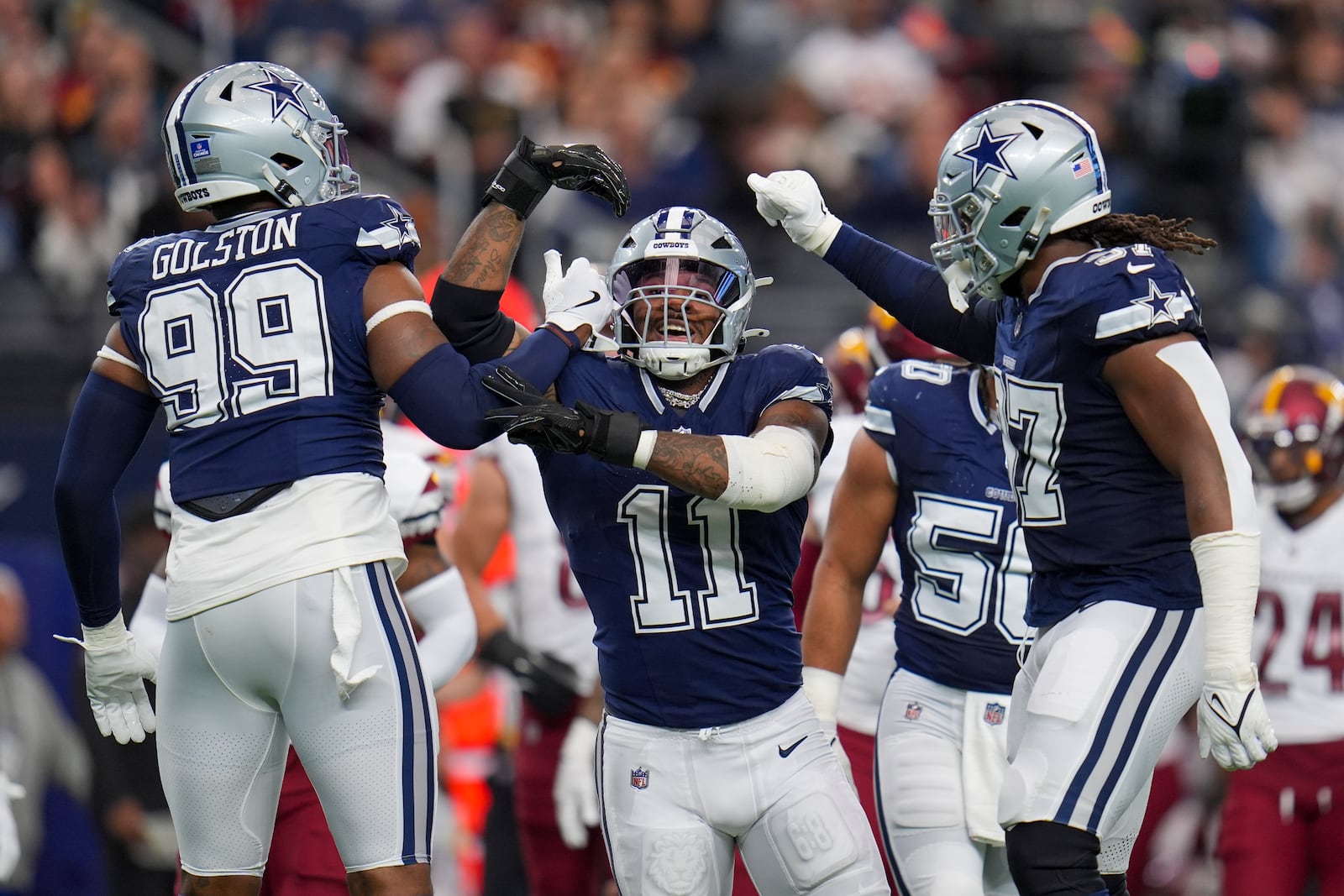 Dallas Cowboys linebacker Micah Parsons (11) celebrates a sack with defensive end Chauncey Golston (99) and linebacker Buddy Johnson (57) during the first half of an NFL football game against the Washington Commanders, Sunday, Jan. 5, 2025, in Arlington, Texas. (AP Photo/Josh McSwain)