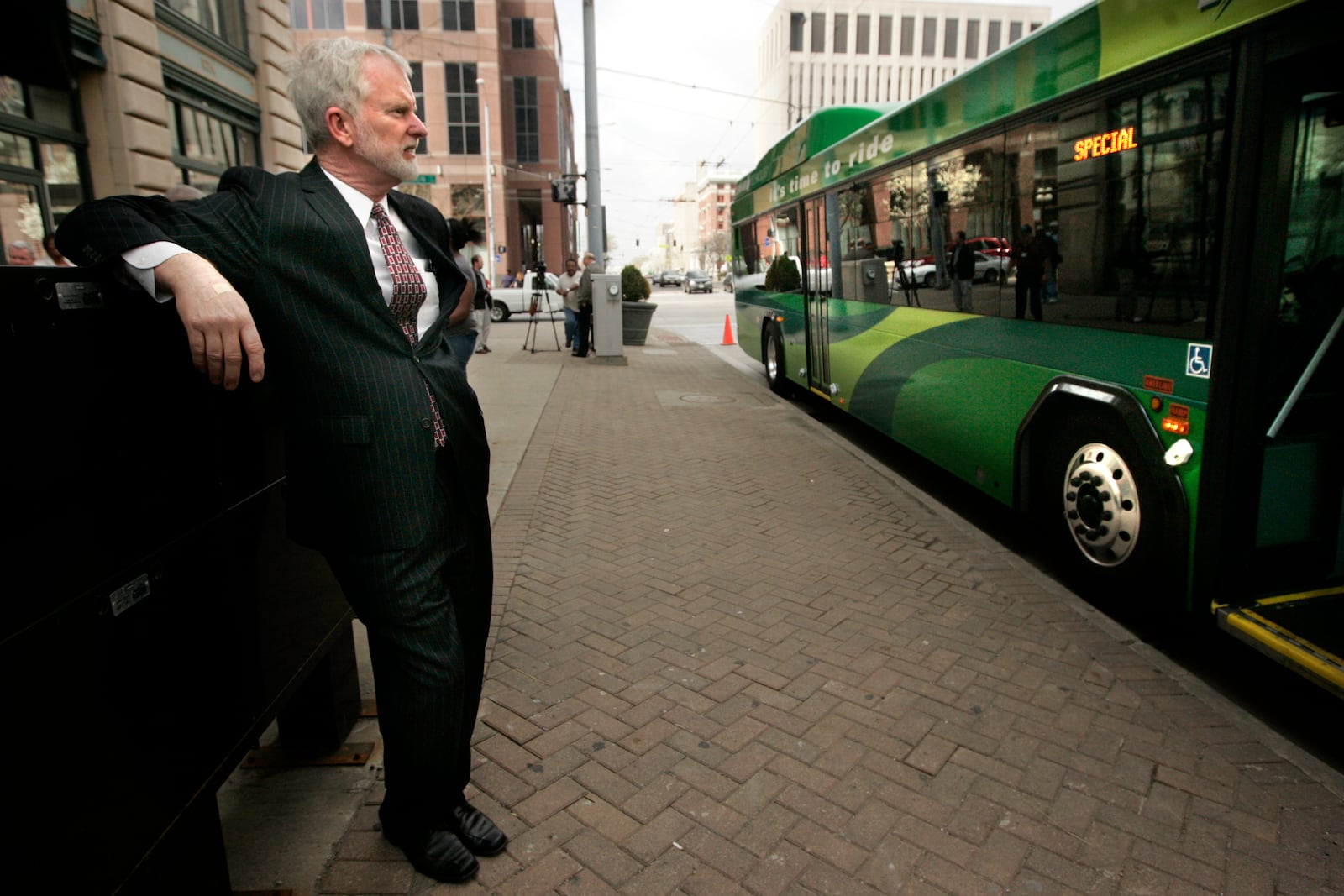 RTA Executive Director Mark Donaghy looks over a new 40-foot hybrid diesel RTA bus unveiled Monday, April 5, at the Wright Stop Transit Center. Ten new hybrids rolled into service\uFEFF. Staff photo by Jim Witmer