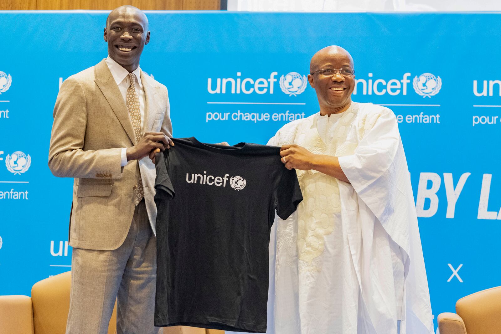 TikTok star Khaby Lame receives a T-shirt from UNICEF Regional Director for West and Central Africa Gilles Fagninou after being named UNICEF Goodwill Ambassador Friday, Jan. 31, 2025 in Dakar, Senegal. (AP Photo/Sylvain Cherkaoui)