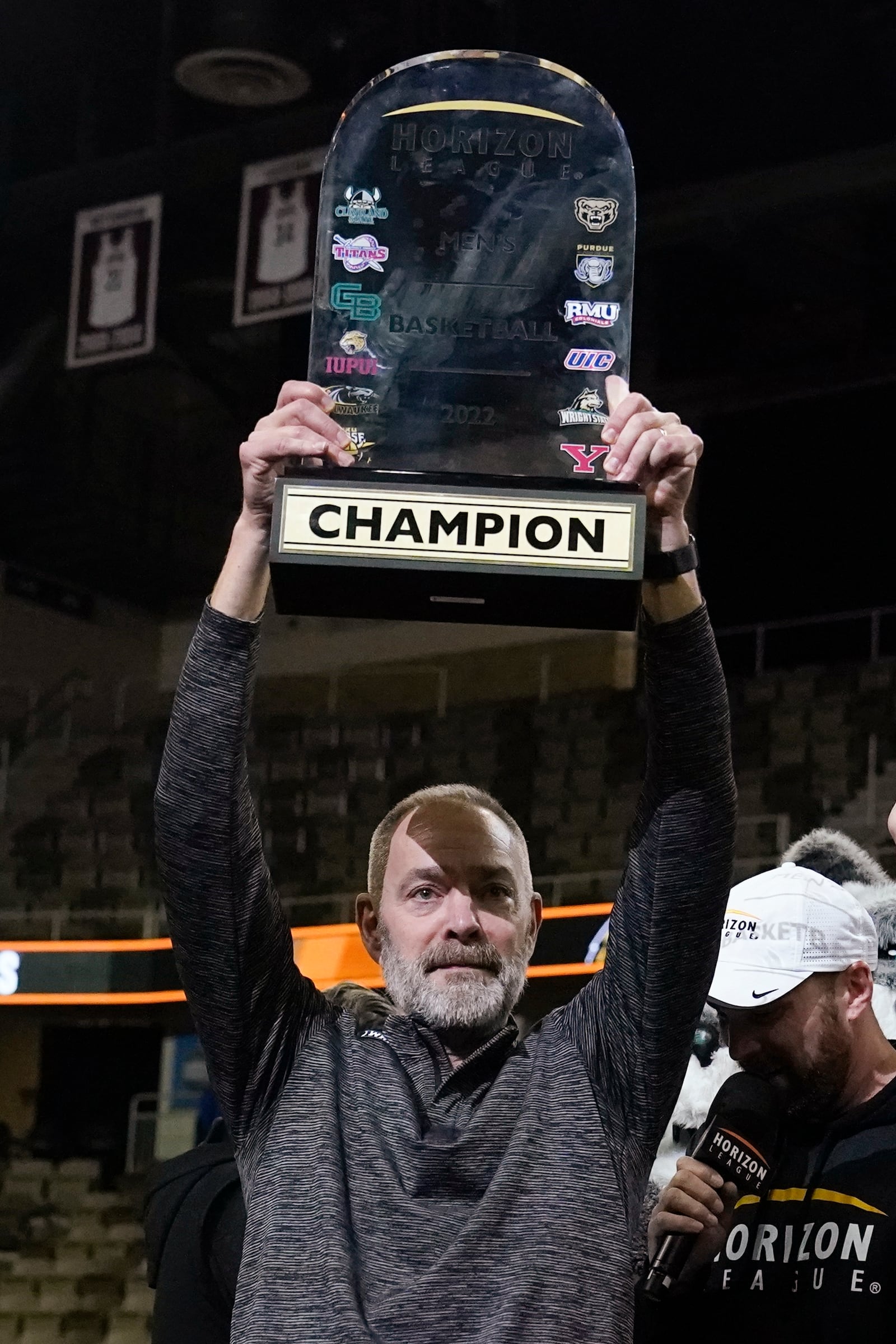 Wright State coach Scott Nagy holds up the trophy after Wright State defeated Northern Kentucky 72-71 in an NCAA college basketball game for the Horizon League men's tournament championship Tuesday, March 8, 2022, in Indianapolis. (AP Photo/Darron Cummings)