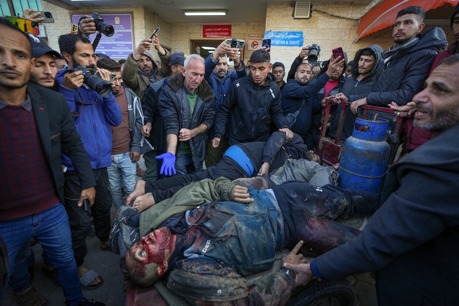 The bodies of four men killed in an Israeli army strike targeting a car are brought to Al-Aqsa Martyrs hospital in Deir al-Balah Friday, Jan. 3, 2025.(AP Photo/Abdel Kareem Hana)