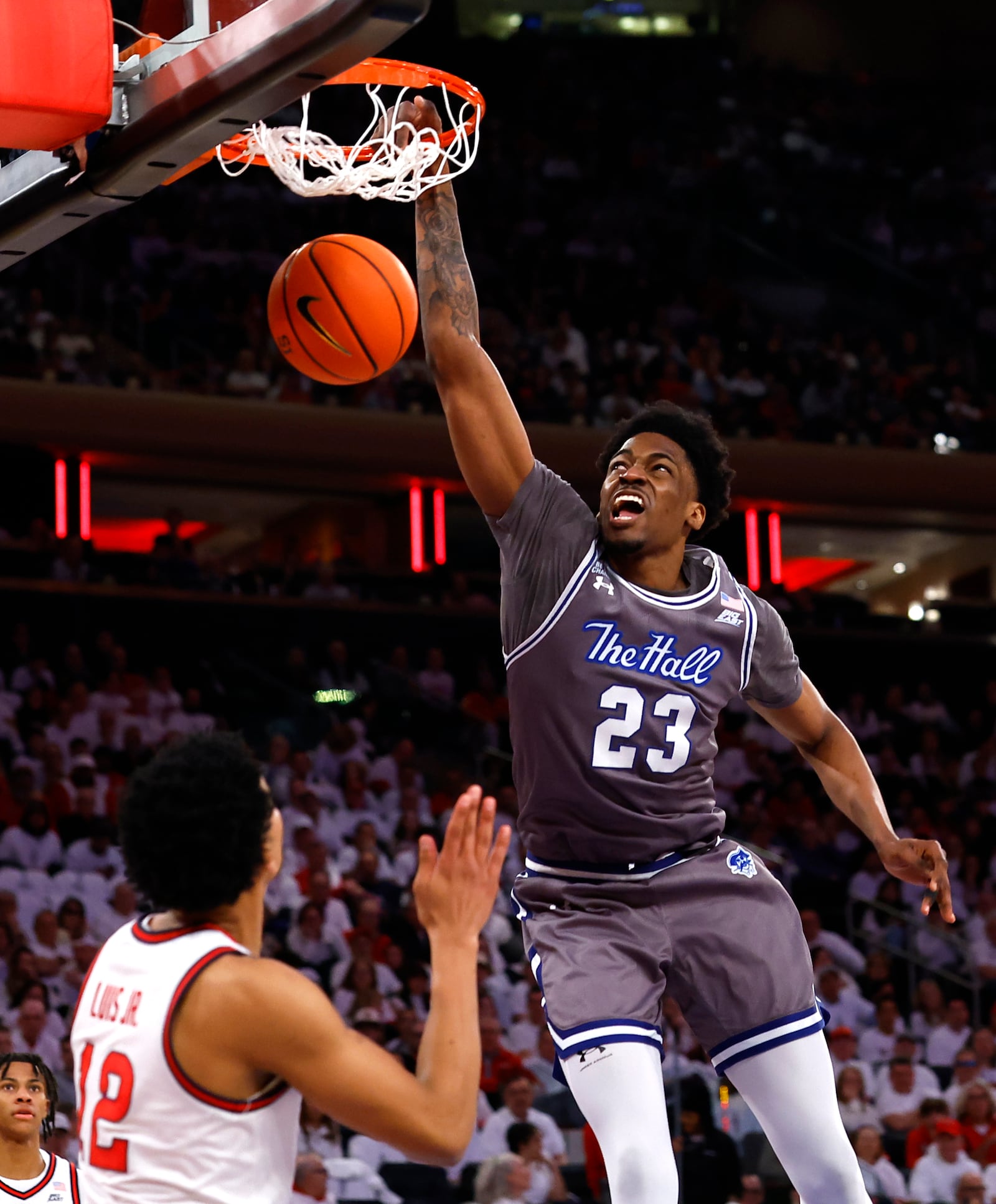 Seton Hall center Emmanuel Okorafor (23) dunks against St. John's guard RJ Luis Jr. (12) during the first half of an NCAA college basketball game, Saturday, March 1, 2025, in New York. (AP Photo/Noah K. Murray)