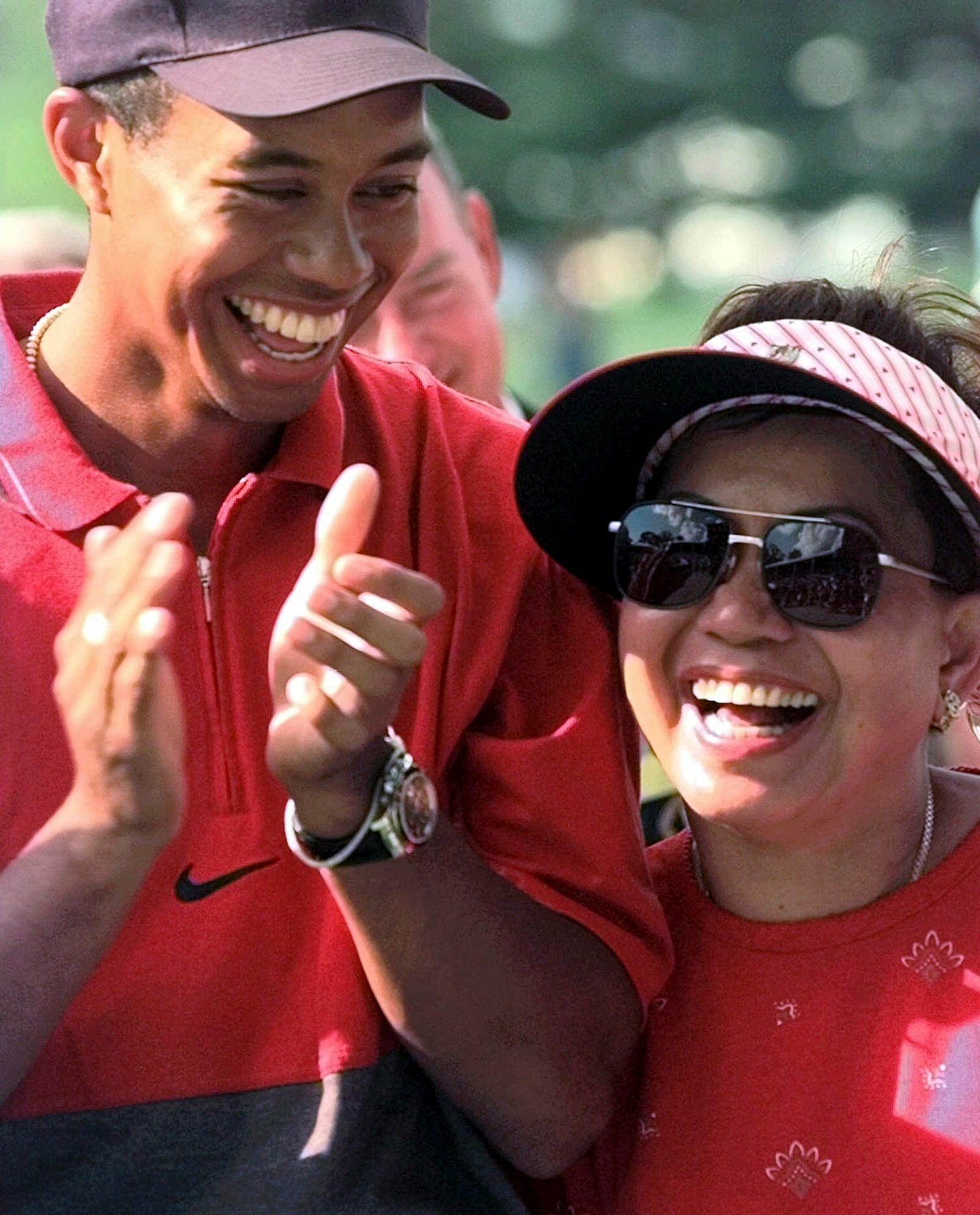 FILE - Tiger Woods enjoys a laugh with his mother, Kultida, after winning the Western Open at Cog Hill Golf & Country Club in Lemont, Ill., Sunday, July 6, 1997. (AP Photo/Frank Polich, File)