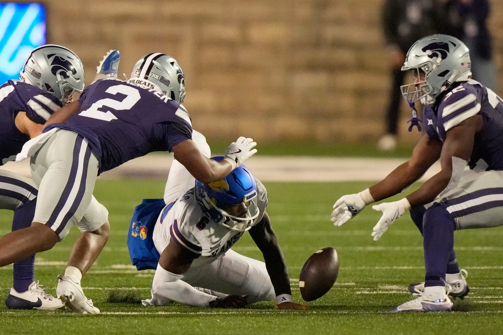 Kansas quarterback Jalon Daniels (6) fumbles the ball after being tackled by Kansas State linebacker Austin Romaine (45) during the second half of an NCAA college football game Saturday, Oct. 26, 2024, in Manhattan, Kan. Kansas State won 29-27. (AP Photo/Charlie Riedel)