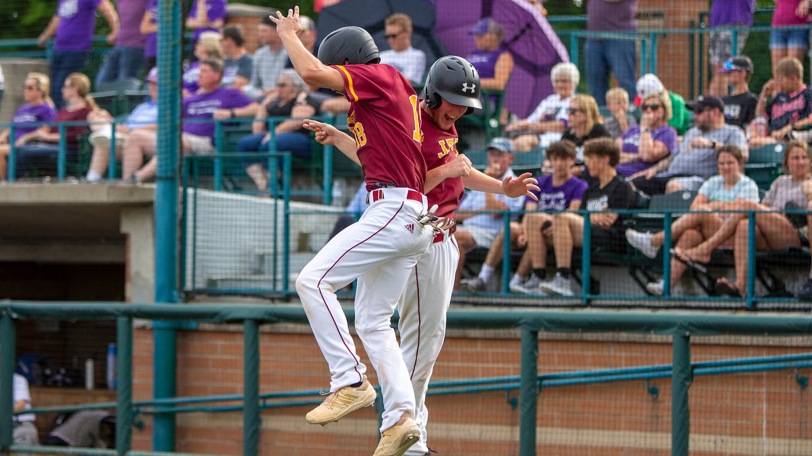 Northeastern's Dylan Haggy (left) and Cole Patterson celebrate after both scored on a single by Seth Hall in the third inning of Thursday's Division III region semifinal against Cincinnati Hills Christian Academy at Wright State. CONTRIBUTED/Jeff Gilbert