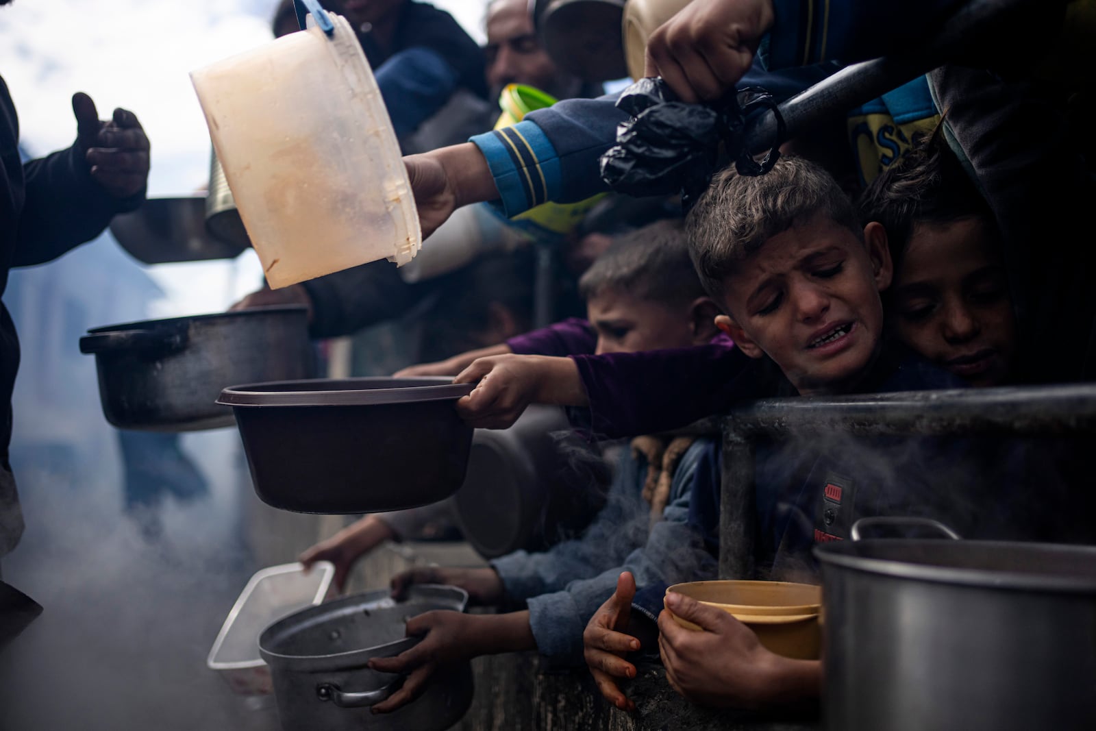 FILE - Palestinians line up for a meal in Rafah, Gaza Strip, Friday, Feb. 16, 2024. (AP Photo/Fatima Shbair, File)