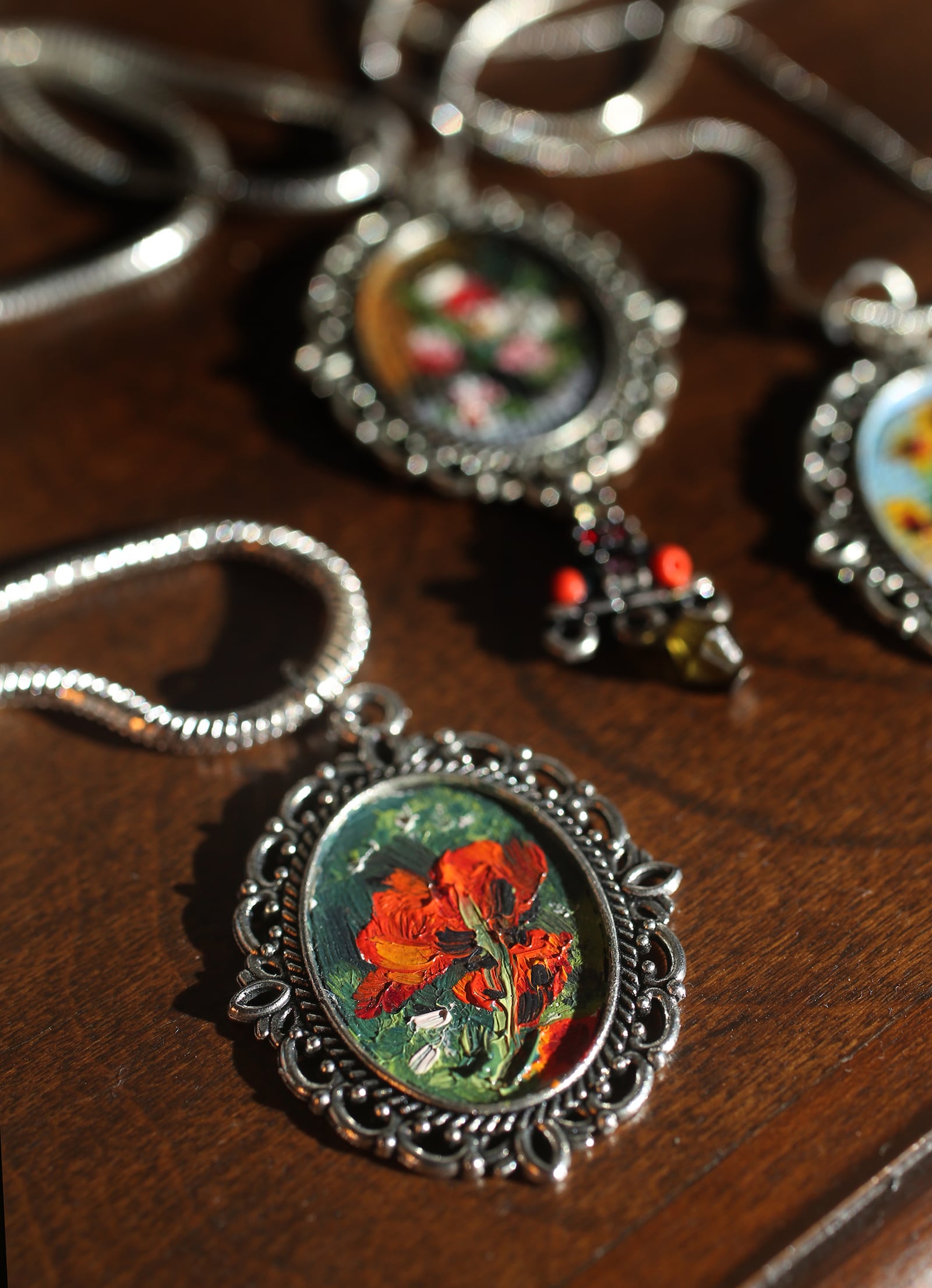 Cecilia Brendel's mini masterpieces, which come in one and two-inch ovals framed in a pendant, are painted with archival oil paints "that will last for centuries" on Belgian oil primed linen. LISA POWELL / STAFF