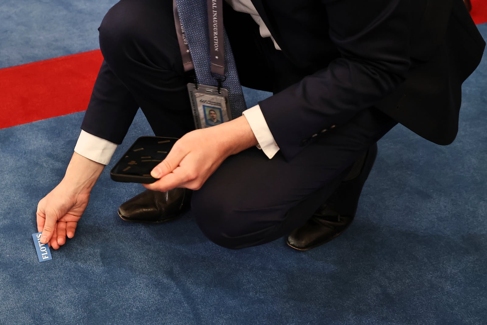 A staff member places a marker for the first lady before the 60th Presidential Inauguration in the Rotunda of the U.S. Capitol in Washington, Monday, Jan. 20, 2025. (Chip Somodevilla/Pool Photo via AP)