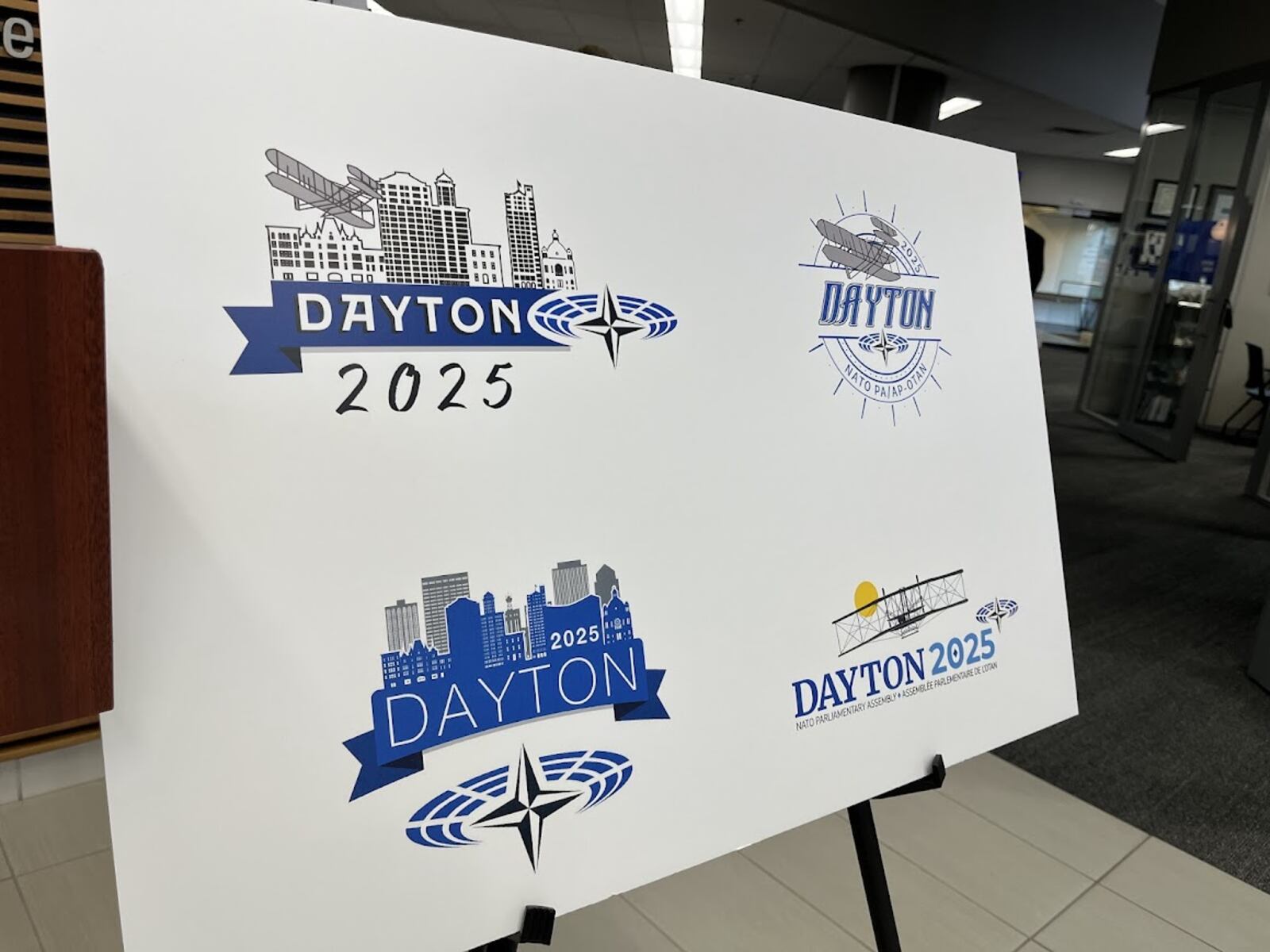 Four of the seven final logo possibilities for the 2025 NATO Spring Parliamentary Assembly, which will be held in Dayton. NATO officials will pick a final logo by Oct. 31. THOMAS GNAU/STAFF