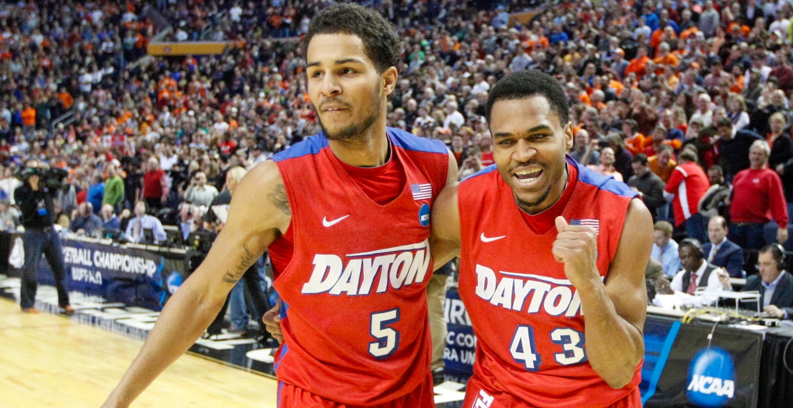 Dayton's Vee Sanford, right, pumps his fist and leaves the court with Devin Oliver after hitting the game-winning shot against Ohio State in the second round of the NCAA tournament on Thursday, March 20, 2014, at the First Niagara Center in Buffalo, N.Y. David Jablonski/Staff 2014 Dayton NCAA Tournament.jpg