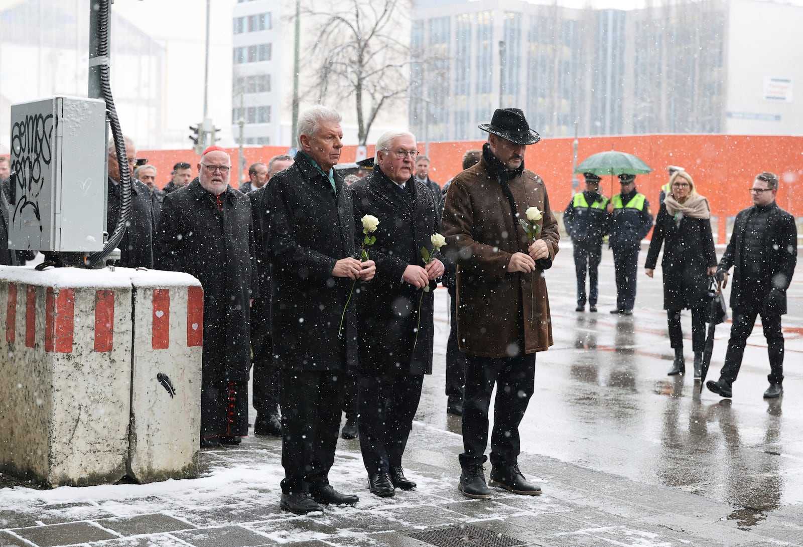 From left: Munich's Lord Mayor Dieter Reiter, German President Frank-Walter Steinmeier and Bavaria's Minister President Markus Söder Silent attend a minute of silence at the site where a car crashed into a demonstration the day before, in Munich, Germany, Friday, Feb. 14, 2025. (Daniel Löb/dpa via AP)